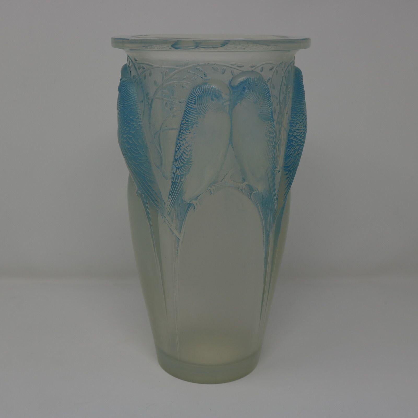 Rene Lalique Opalescent Glass 'Ceylan' Vase. Blue staining to details. This pattern features parakeets, side by side. Wheel cut and engraved makers mark, 'R. LALIQUE FRANCE No.905'. Book reference: 'R. LALIQUE Catalogue Raisonne De L'Oeuvre De