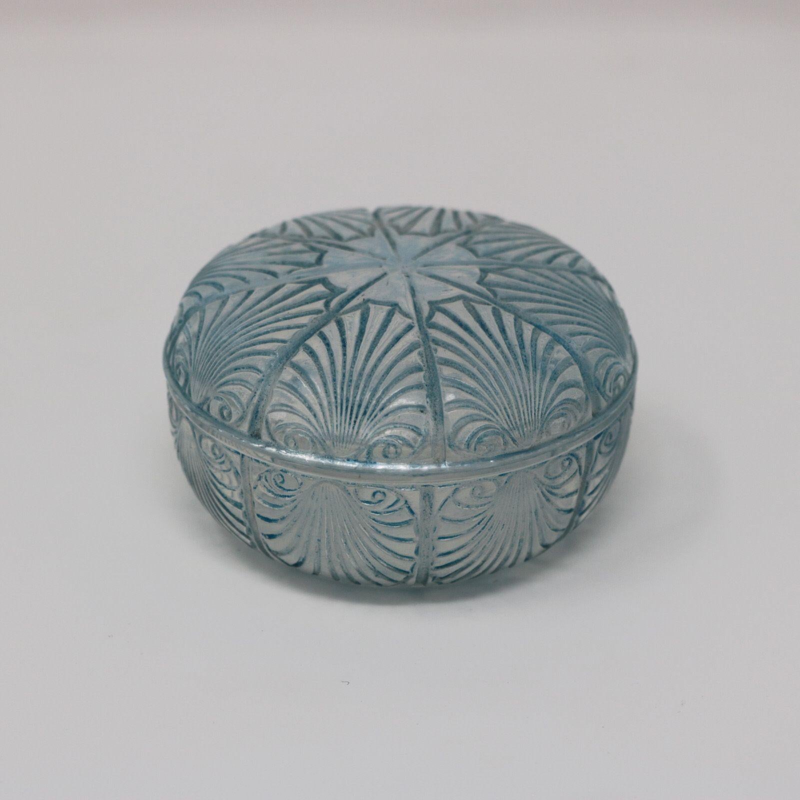 Rene Lalique opalescent glass, 'Coquilles' box. Blue stained detailing. This pattern features cockle shells. Stencilled makers mark to the underside of the base, 'R LALIQUE'. Book reference: Marcilhac 71.