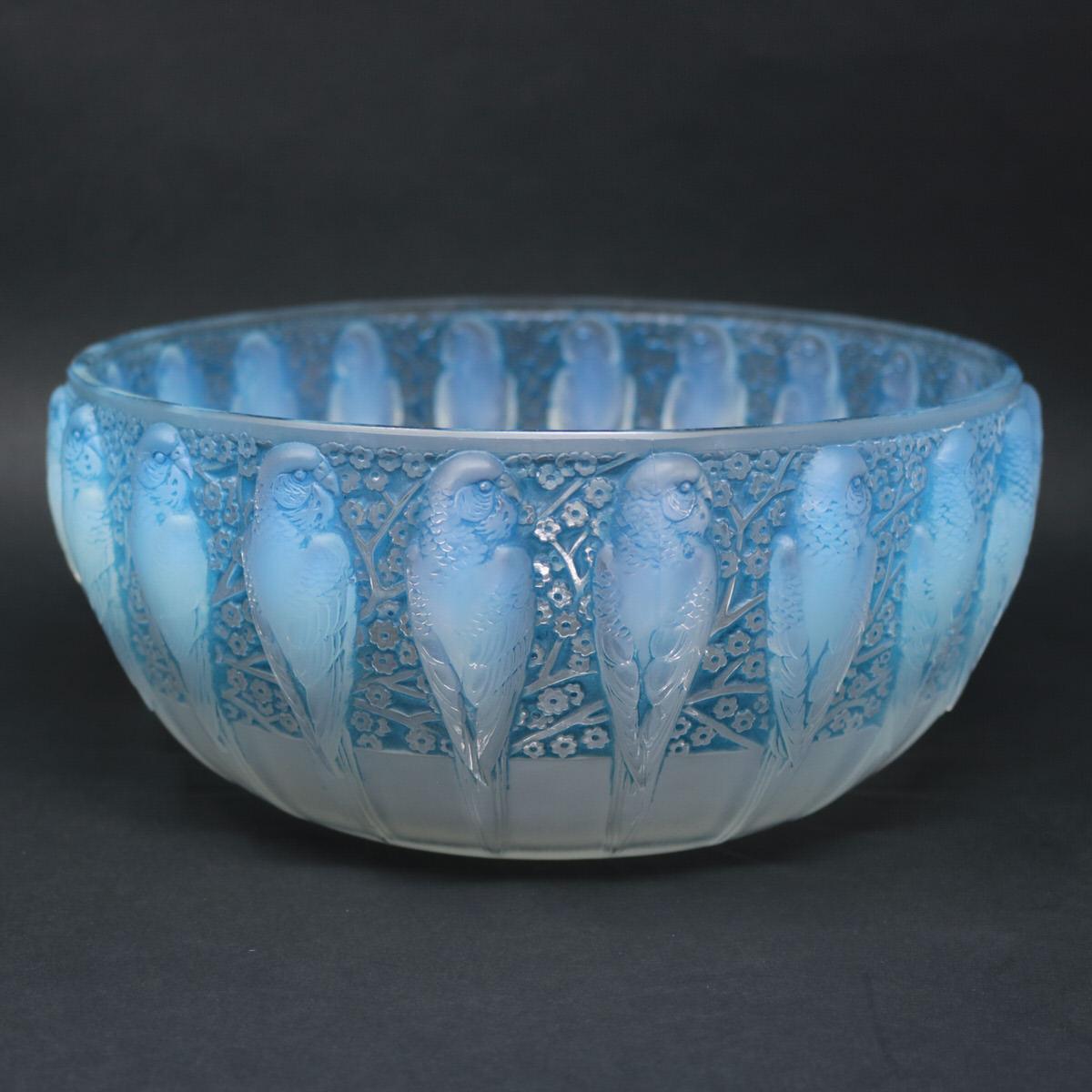 Rene Lalique opalescent glass 'Perruches' bowl. Blue stain details. This pattern features parakeets around the outside, with flowers in-between. Stenciled makers mark, 'R. LALIQUE FRANCE' to the underside. Book reference: Marcilhac 419.