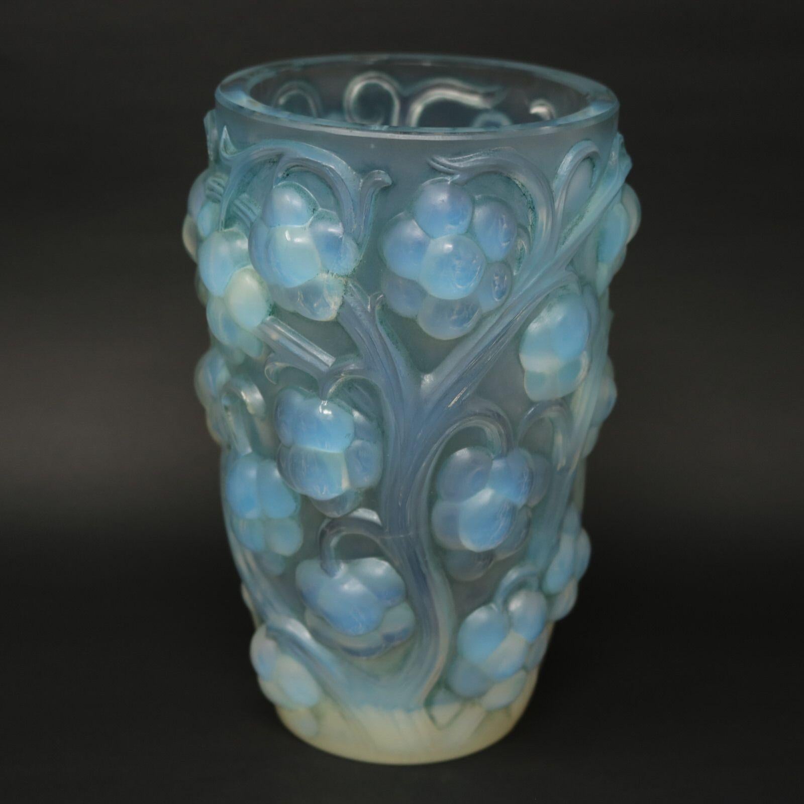 Rene Lalique Opalescent glass 'raisins' vase, with blue stained details. This pattern features deep relief grape bunches, hanging from vines. Stenciled makers mark, 'R LALIQUE FRANCE'. Book reference: 'R. LALIQUE Catalogue Raisonné De L'Oeuvre De