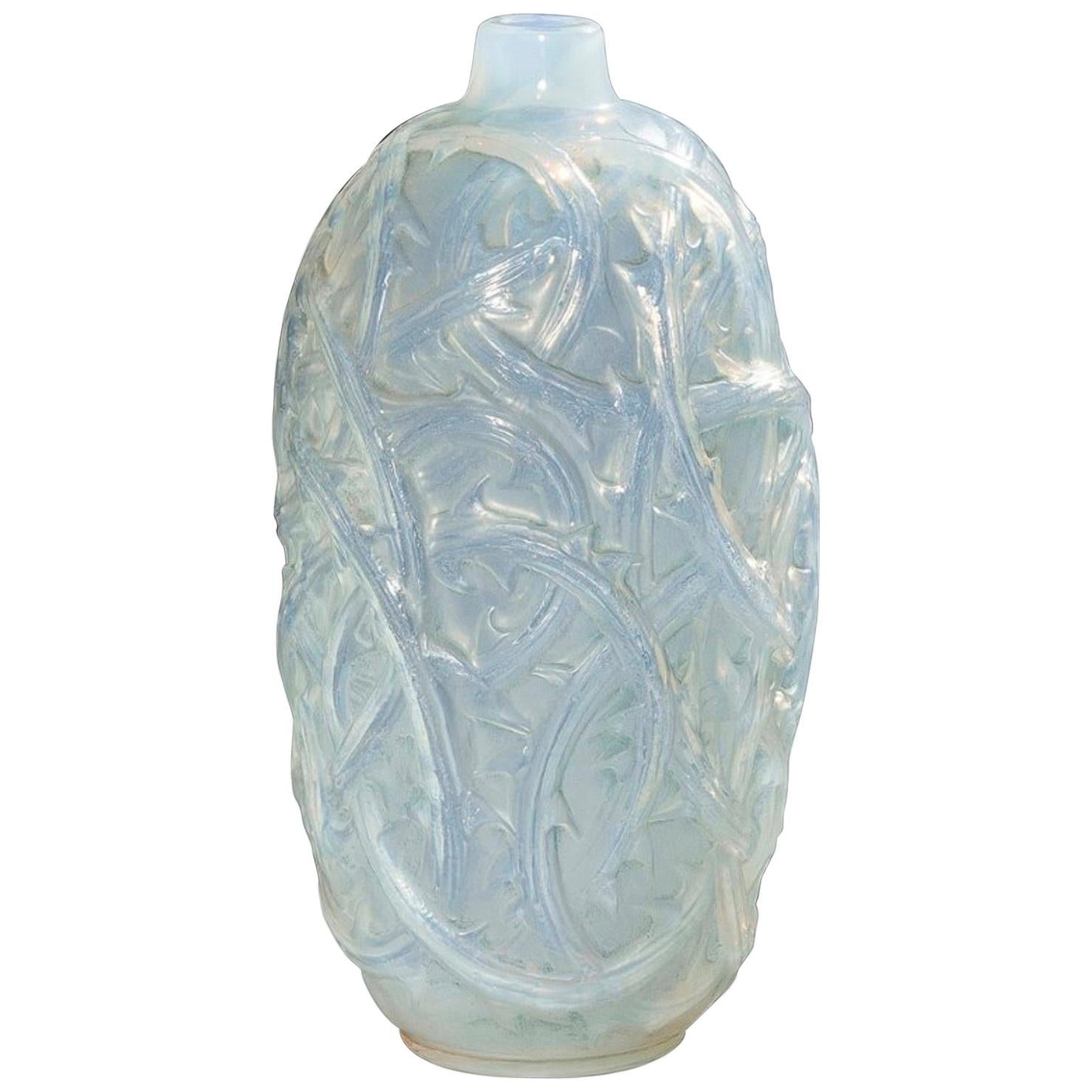 Lalique Vase Ronces: 24 cm tall.
cylindrical briars motif white opalescent and green patinated glass 
opalescent decorated narrow soliflor glass R. Lalique vase.
Rene Lalique ronces vase no. 946.
Félix MARCILHAC, 
