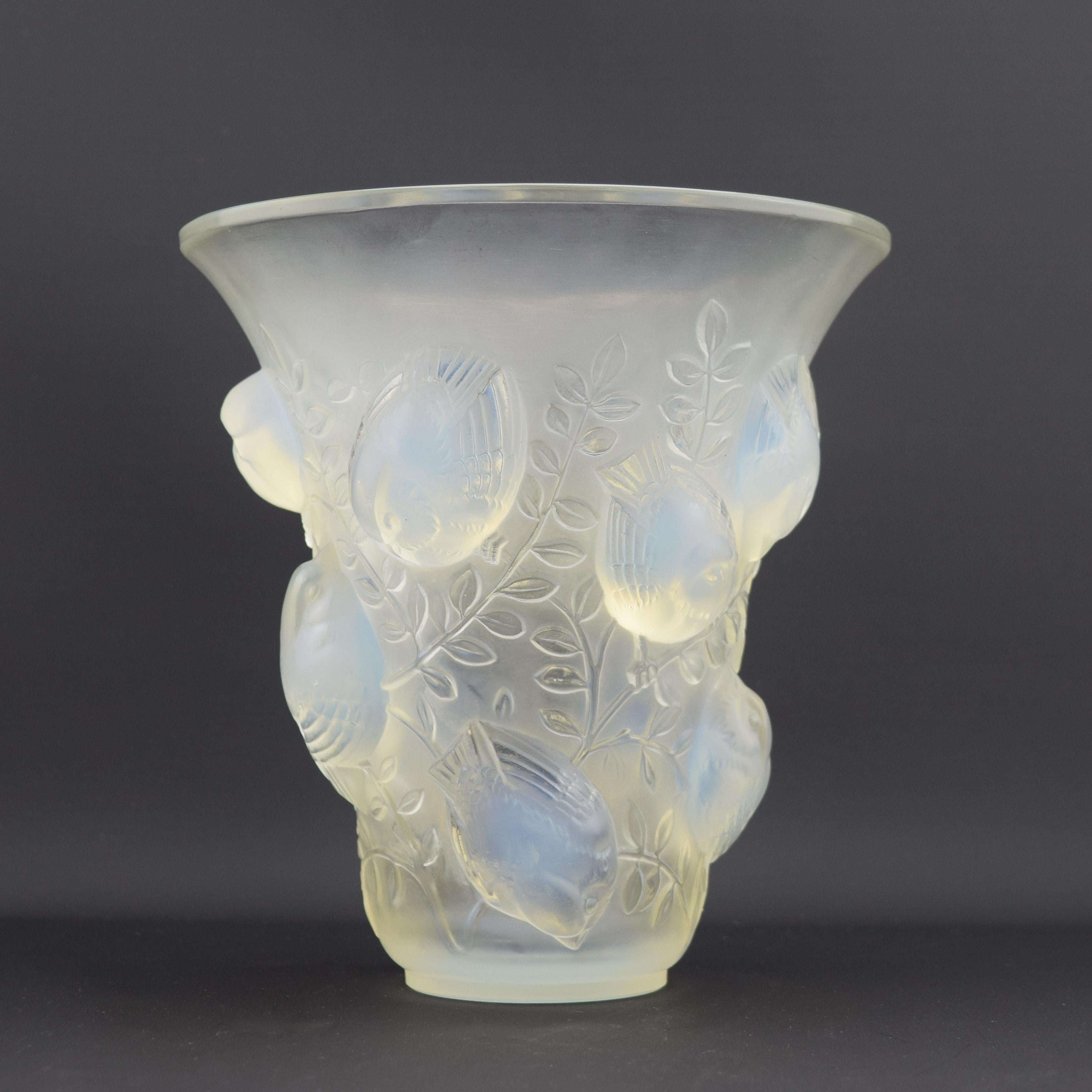 Rene Lalique opalescent St Francois vase

Introduced jn 1930
Marcilhac page ref: 450
Model 1055

The condition is very good.
There are some light scratches to the inner rim and a fine mouldline 
The base also has lots of wear marks

Stenciled mark