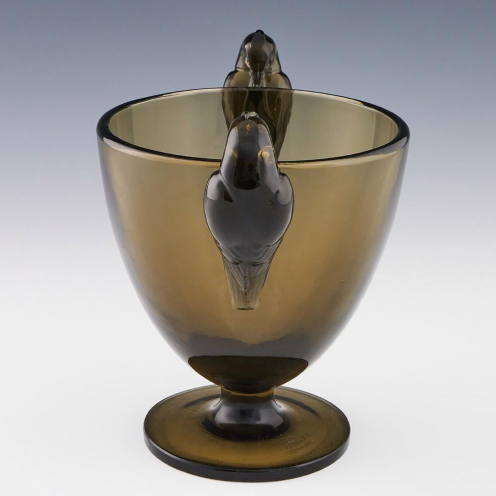 Heading : Rene Lalique Ornis vase
Date : Designed 1926
Origin : Wingen-sur-Moder, France
Bowl Features : Topaz glass in round funnel form with two birds (ornis in English).
Marks : Stencilled R Lalique France mark
Type : Lalique demi-cristal
Size :