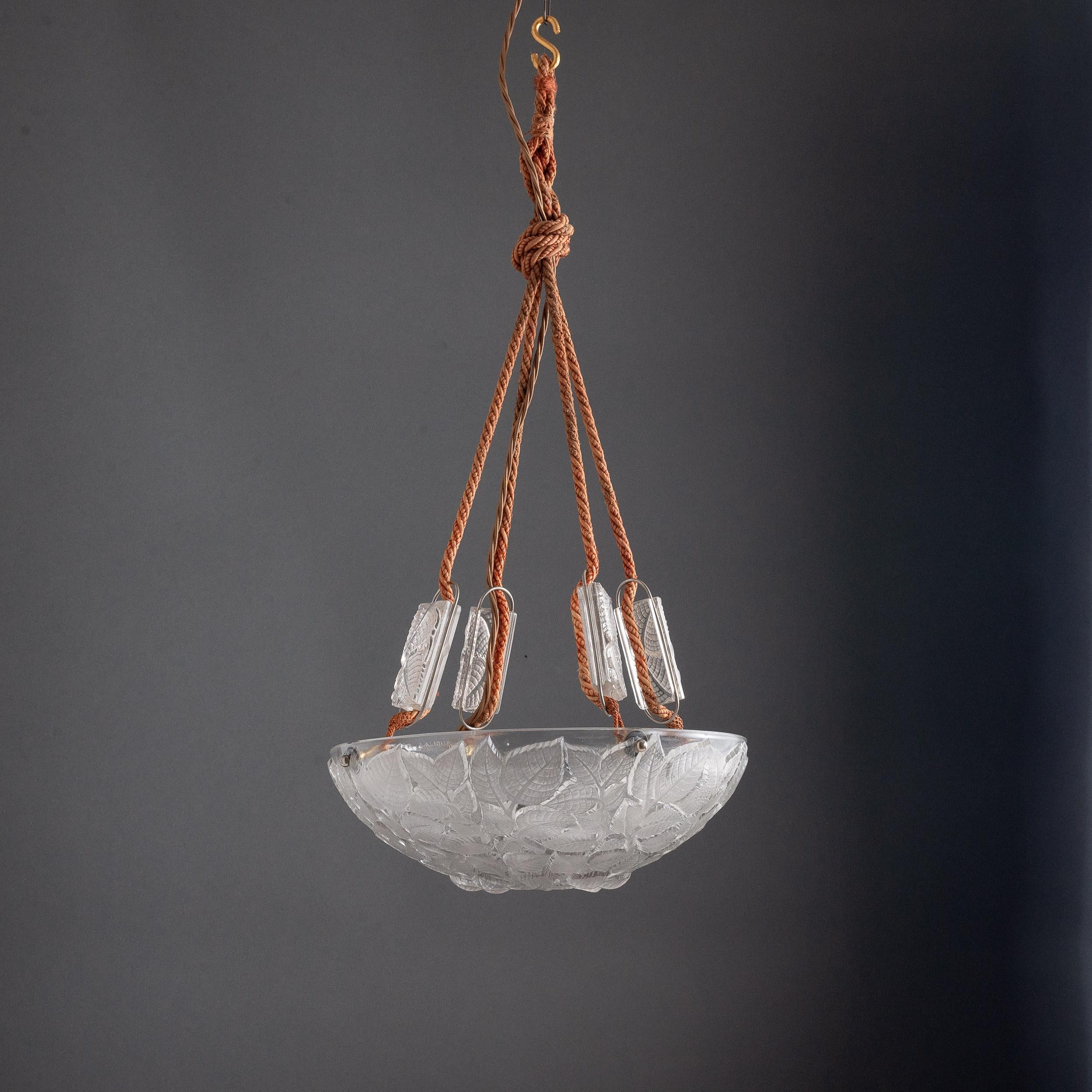 A Rene Lalique Plafonnier, 'Charmes', model 2458, designed 1924, the moulded glass dish with birch leaf decoration, re-wired.
Bowl height is 12 cm