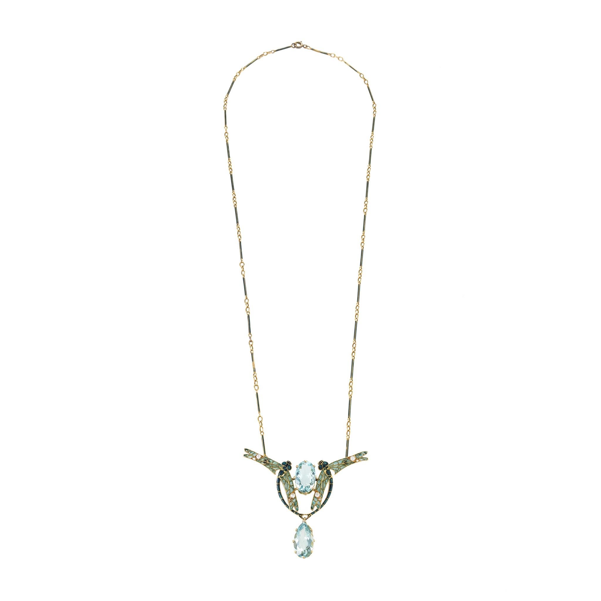 This exquisite gold pendant necklace by the Art Nouveau master, René Lalique, features two plique-à-jour enamel dragonflies, aquamarines, and diamonds. The pair of dragonflies with delicately-shaded plique-à-jour enamel and diamond wings flank a