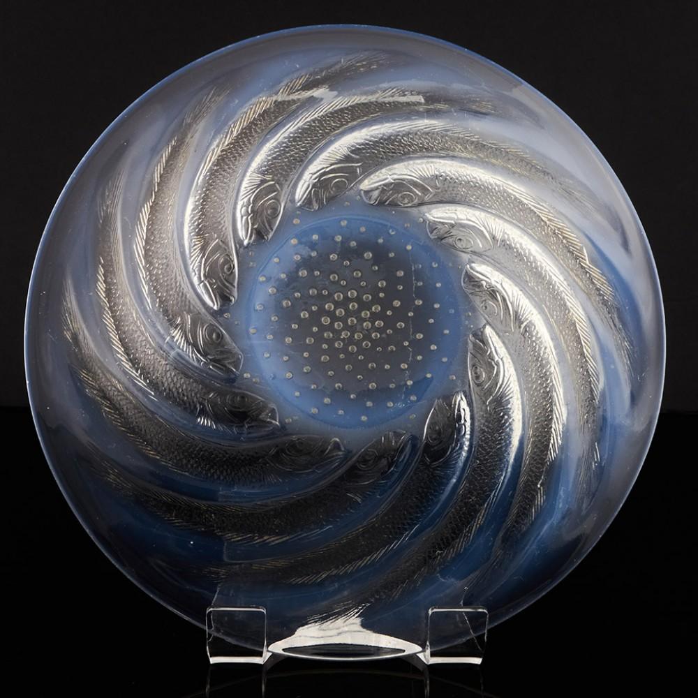Heading : Rene Lalique Poissons coupe-ouverte
Date : Designed 1921
Origin : Wingen-sur-Moder, France
Bowl Features : A spiral of sardines with a field of bubbles at the base of the bowl - opalescent
Marks : Moulded R Lalique mark
Type : Lalique