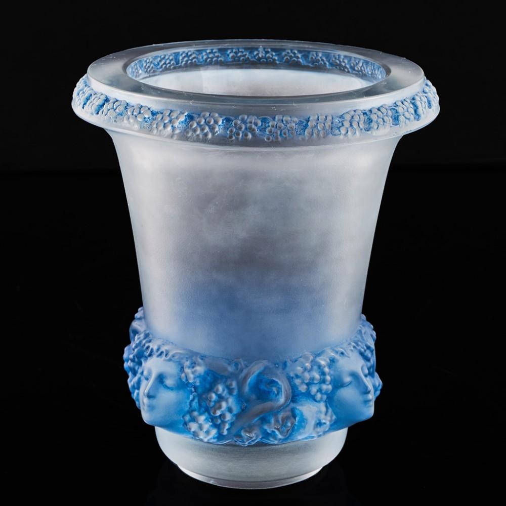 Heading : Rene Lalique Quatre Têtes Femmes Et Raisins vase
Date : Designed 1939
Marks : Acid etched R Lalique to base
Origin : Wingen-sur-Moder, France
Decoration : Clear and frosted glass with blue staining. Moulded design featuring bunches of