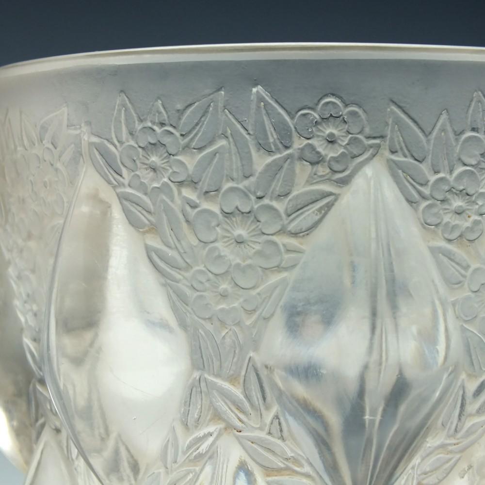 René Lalique Rampillon vase Marcilhac 991

Tapering body with large protruding diamonds and moulded flowers between

Designed 1927

Signed R Lalique France to the base.

