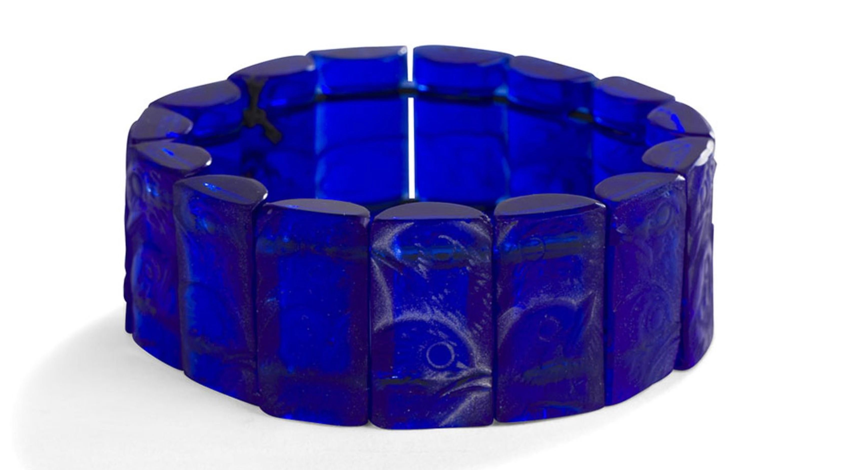 Rene Lalique Bracelet Poussins: 15 cobalt blue Rene Lalique glass pieces 1 inch by 1/2 inch strung on elastic bands.RENÉ LALIQUE (1860-1945) Poussins, model created on [January 20, 1928] and abolished in 1937 Stretch bracelet with 15 elements.