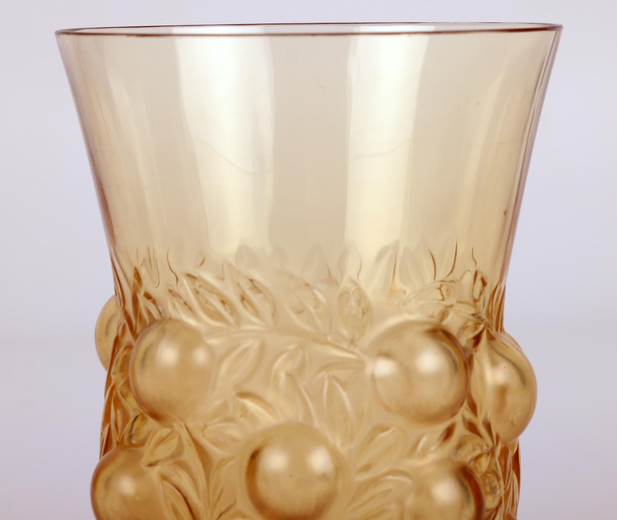 A stunning French amber glass beaker in the Setubal design by world renowned jeweller, medallist and glass designer René Jules Lalique (French, 1860-1945) and dating from around 1931. This finely made example is molded in very thin amber colored