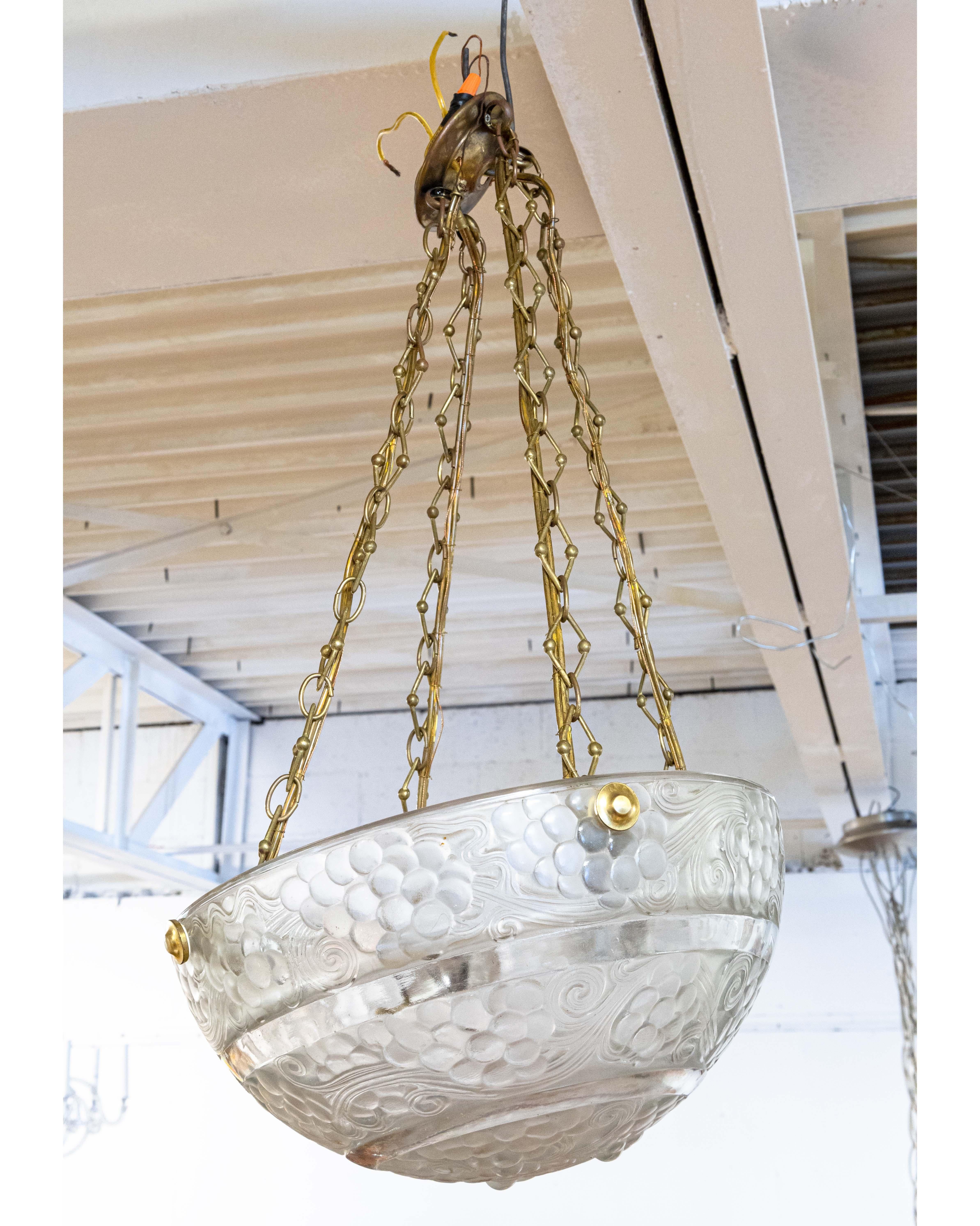 A René Lalique signed St Vincent crystal light pendant. An absolutely jaw-dropping example of a genuine art deco René Lalique glass piece. This light pendant/chandelier features a half dome shape, detailed in molded grapes and flowing lines. The rim