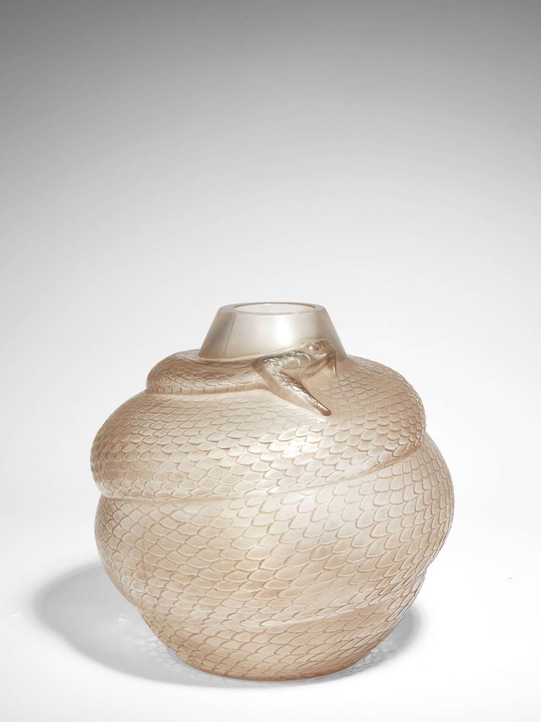 A white blown-moulded glass vase with sepia patina. Signed.