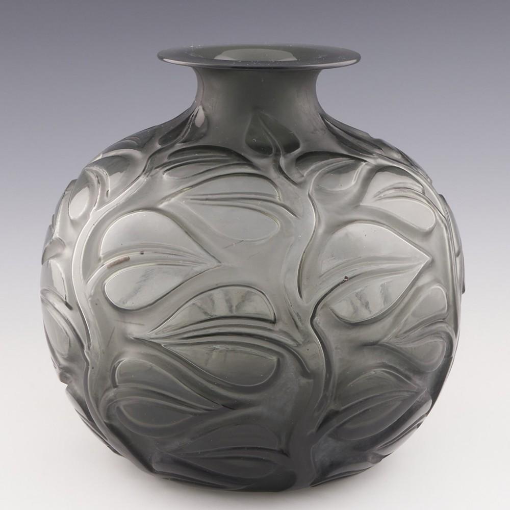 Rene Lalique Sophora Vase, Designed 1926

The colour is not an external stain. It is within the glass itself

Additional information:
Date : Designed 1926 . Marcilhac 977
Origin : Wingen-sur-Moder, France
Bowl Features : High relief leaves and