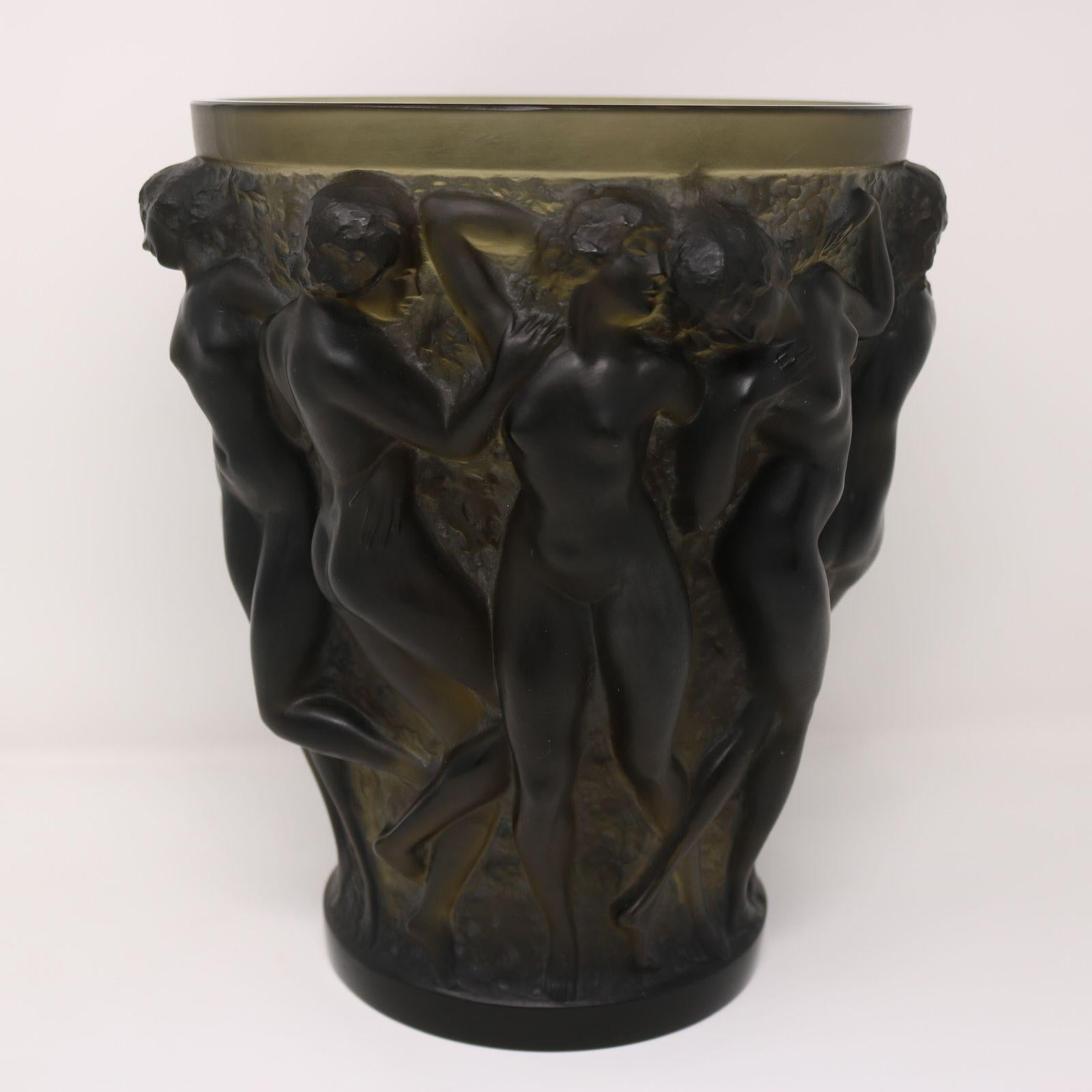 Rene Lalique Topaz glass Bacchantes vase. This pattern features ten dancing nude women in relief. The women represent Bacchantes from Greek mythology, who were a group of women who followed Dionysus on his travels. Wheel cut makers marks, 'R LALIQUE