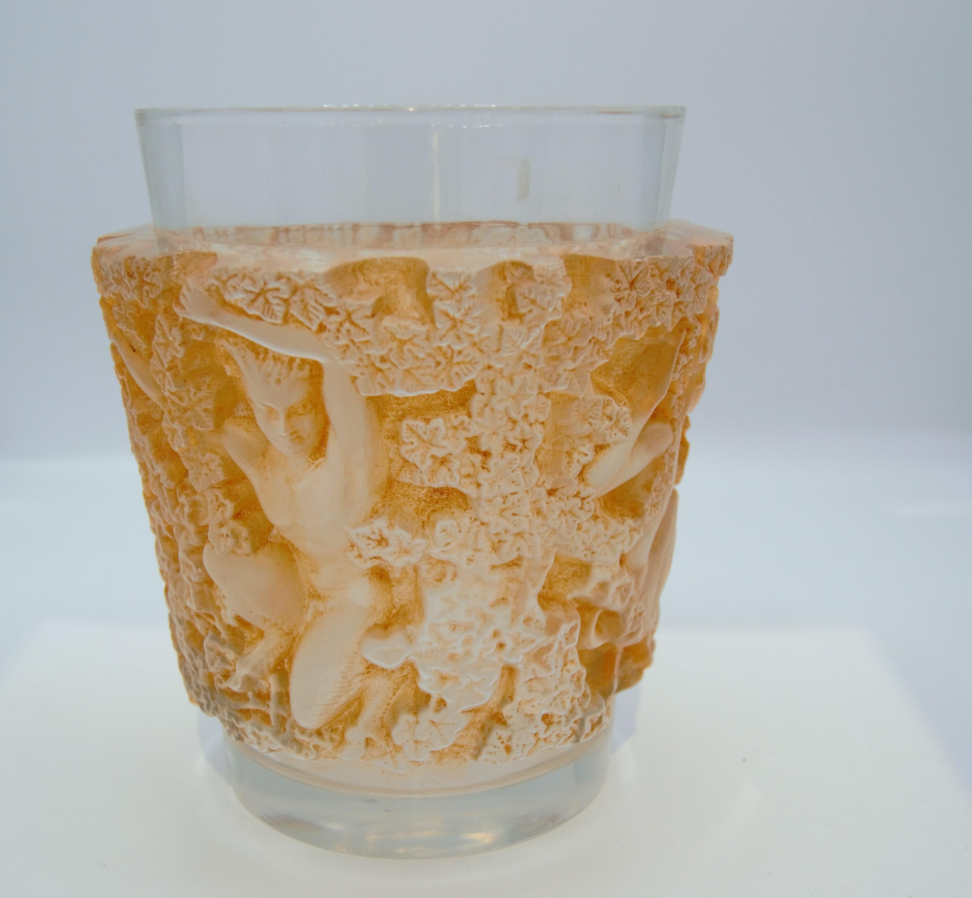 'Bacchus' a Lalique clear and frosted glass vase
No. 10-922, designed 1938, signed R. Lalique, France.
Moulded with fauns and trailing ivy, heightened in orange
Measures: 7 in. (18 cm.) height
Pan style figural motif.