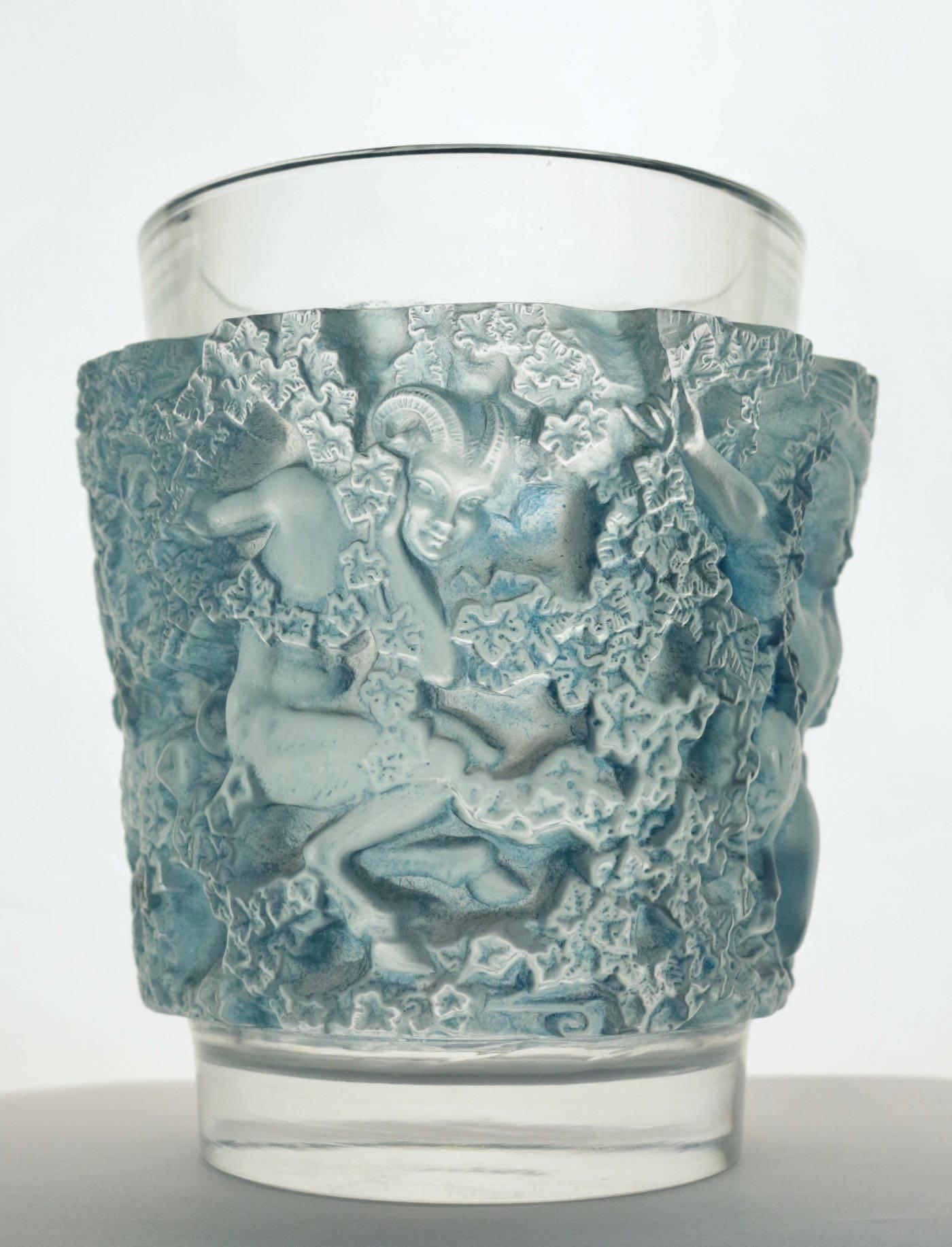 'Bacchus' a Lalique clear and frosted glass vase
No. 10-922, designed 1938, signed R. Lalique, France.
Moulded with fauns and trailing ivy, heightened in blue
Measures: 7 in. (18 cm.) high
pan style figural motif.