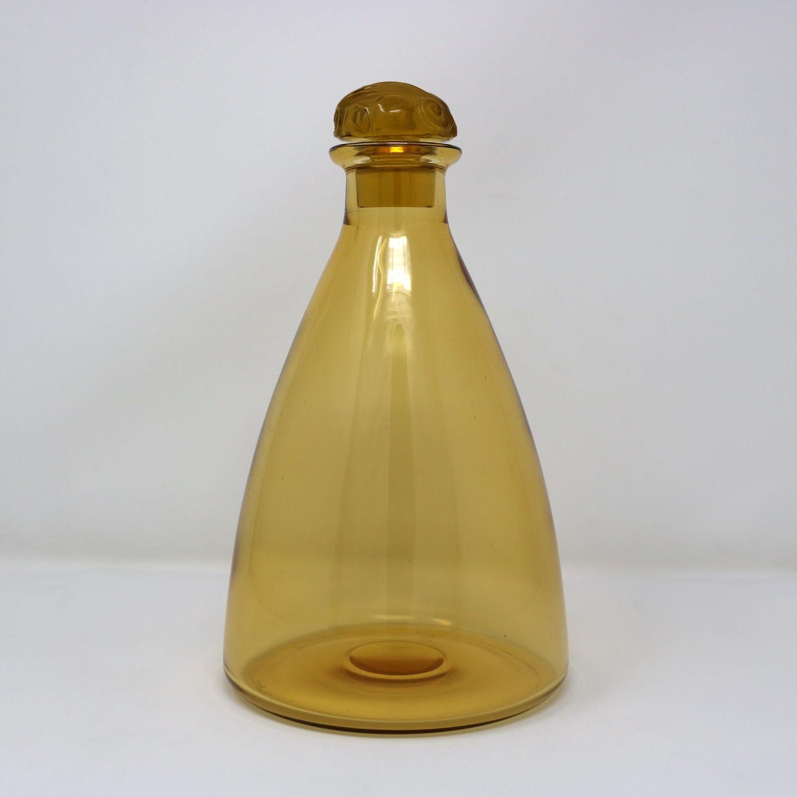Rene Lalique yellow-amber glass 'Marienthal' decanter. Has a conical shaped bottle. The clear and frosted glass stopper has grapes and vine decoration. Inscribed makers mark, 'R Lalique France' and '5126' to the base. Book reference: 'R. LALIQUE