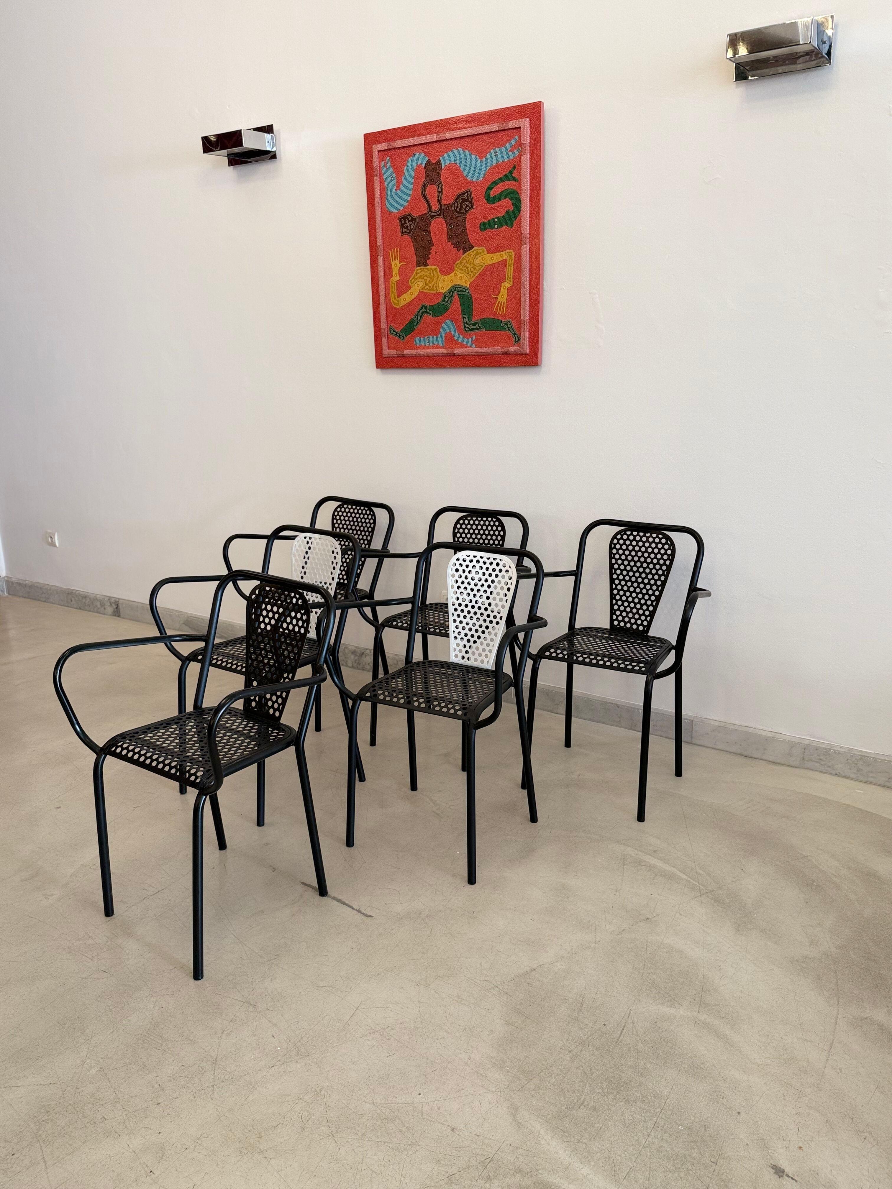 Rare set of six 20th century vintage collectible chairs (four black, two black and white) René Malaval, a key French designer of the 1950s–60s, repurposed perforated steel sheets once intended
for military use into strikingly modern outdoor