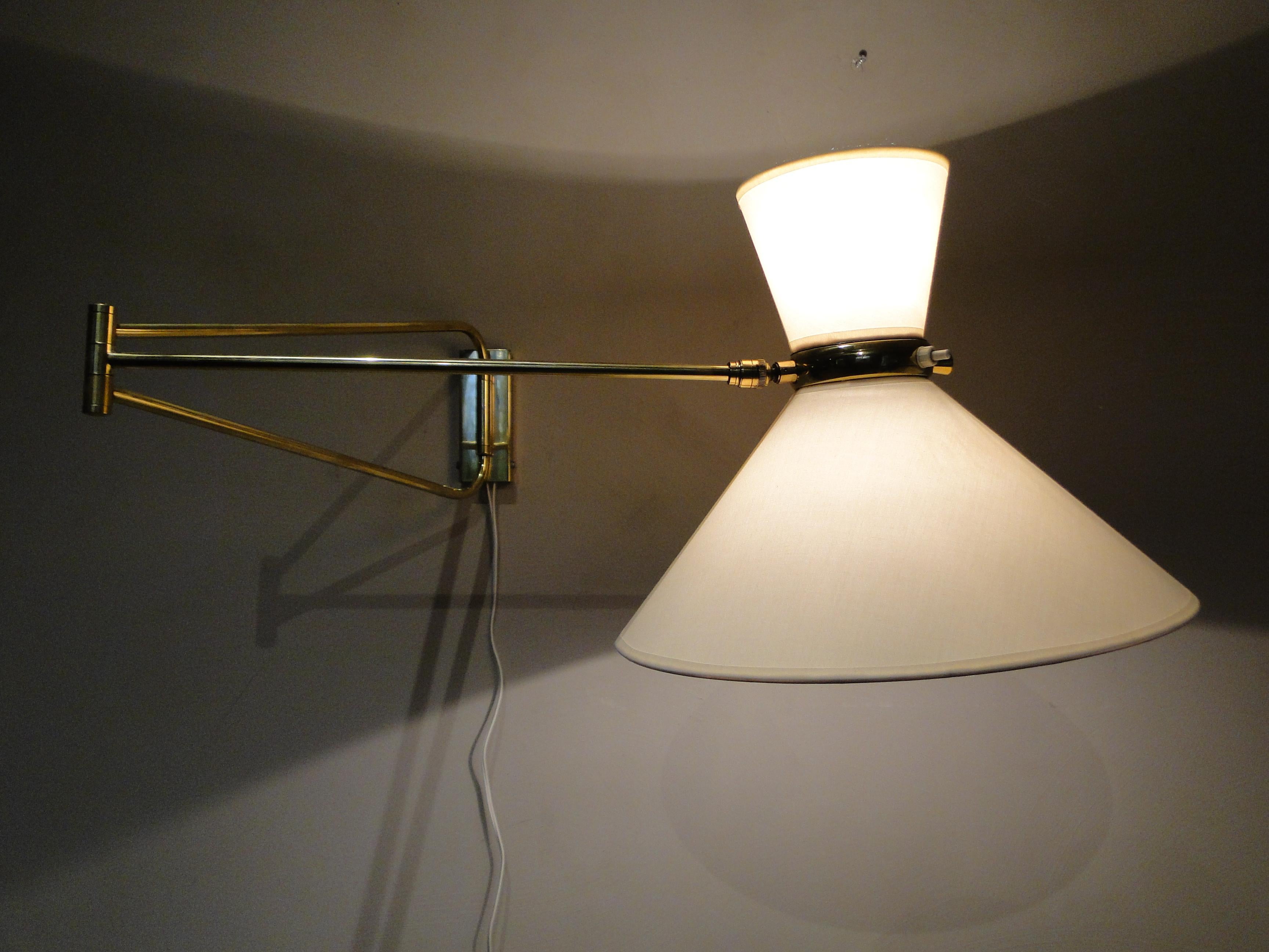 Vintage very large wall lamp by René Mathieu 1950 France.

Wall light by René Mathieu from the 1950s.

2-Arm articulated brass stem.

The double bulb sconce has independent switches for the up and down lights. 

New diabolo lampshade.

36 cm in and
