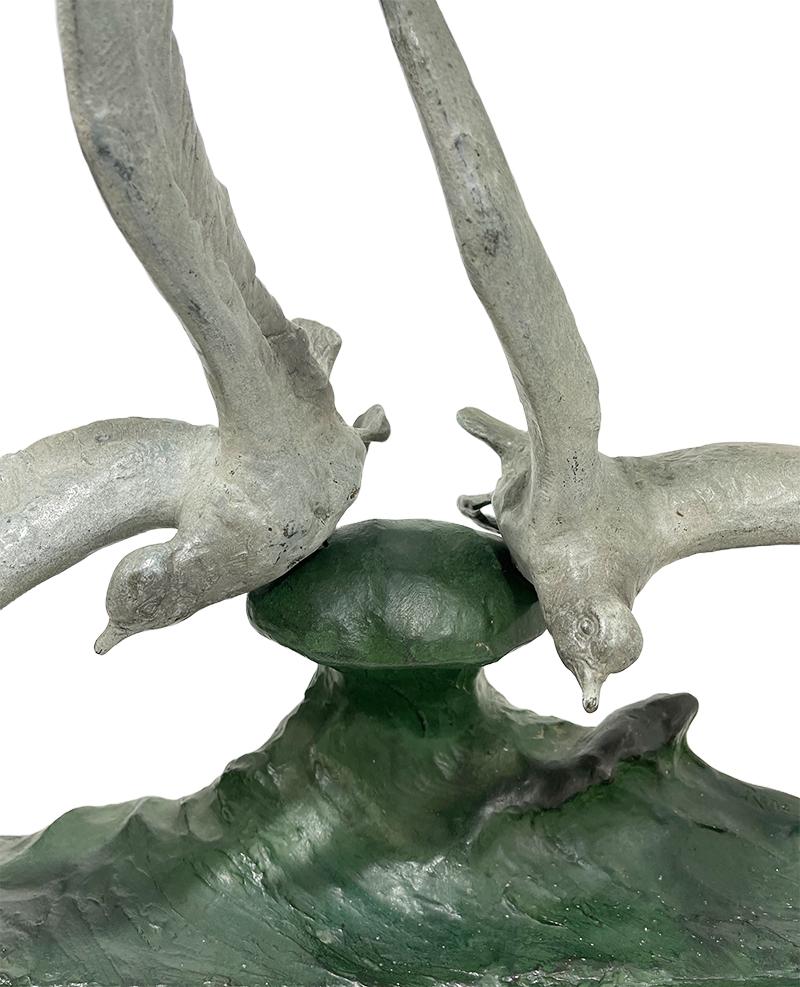 Rene Papa, French sculptor 19th - 20th century bronze sculpture, 1930s.

A bronze with green patina sculpture of birds flying on a sea wave on a base of black marble. Signed right back. The birds are separate and mounted loose by pin on the