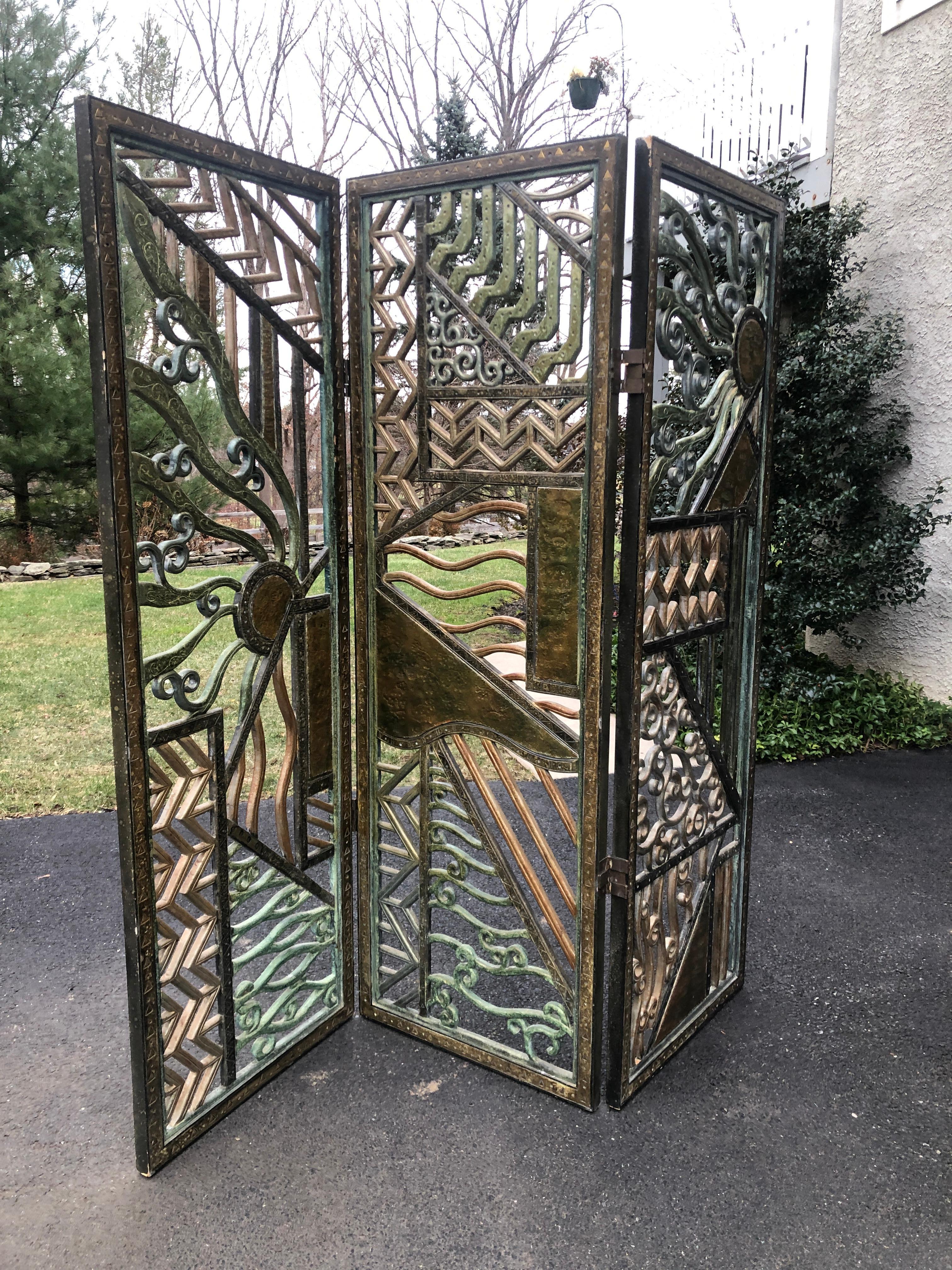 Room divider Art Deco screen Rene Paul Chambellan style mixed metal
Three part folding screen of mixed materials bronze, gesso, painted, punch bronze metal work
72.5 tall 6 feet wide
Three sections all original.
  
