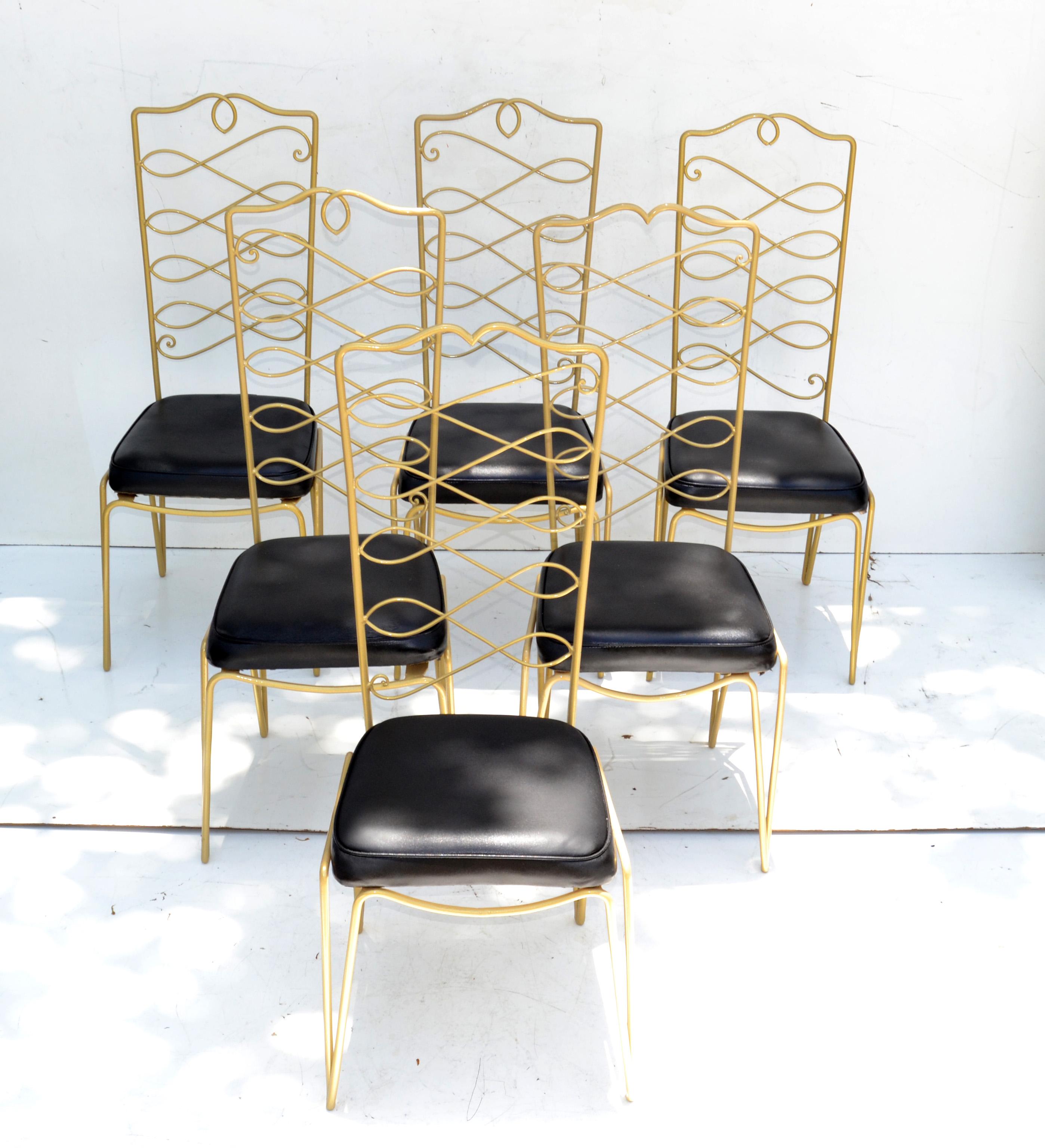 Superb set of six Art Deco wrought iron dining chairs golden powder coated finish by rene prou in the 1940s style.
The set contains 4 highbacked chairs and 2 side chairs with different backrest design.
Seat is covered in a black vinyl.
Measures: