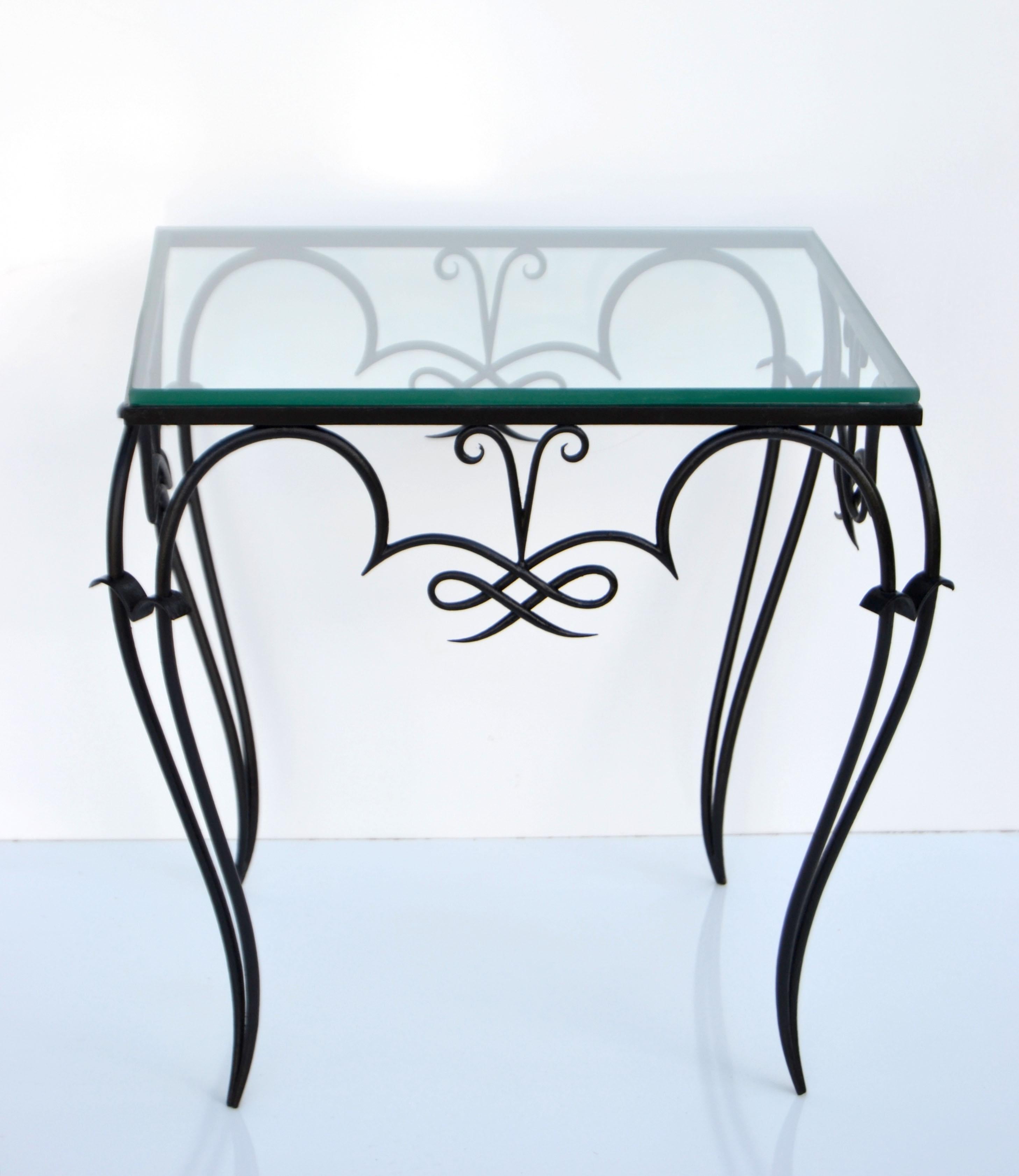 Whimsical Art Deco René Prou style black wrought iron & glass top side or end table made in France in the late 1940.
Ready for a new Home.
Refinished very good condition with new glass top.
Glass Top measures: 19.5 x 19.5 x 0.25 inches.