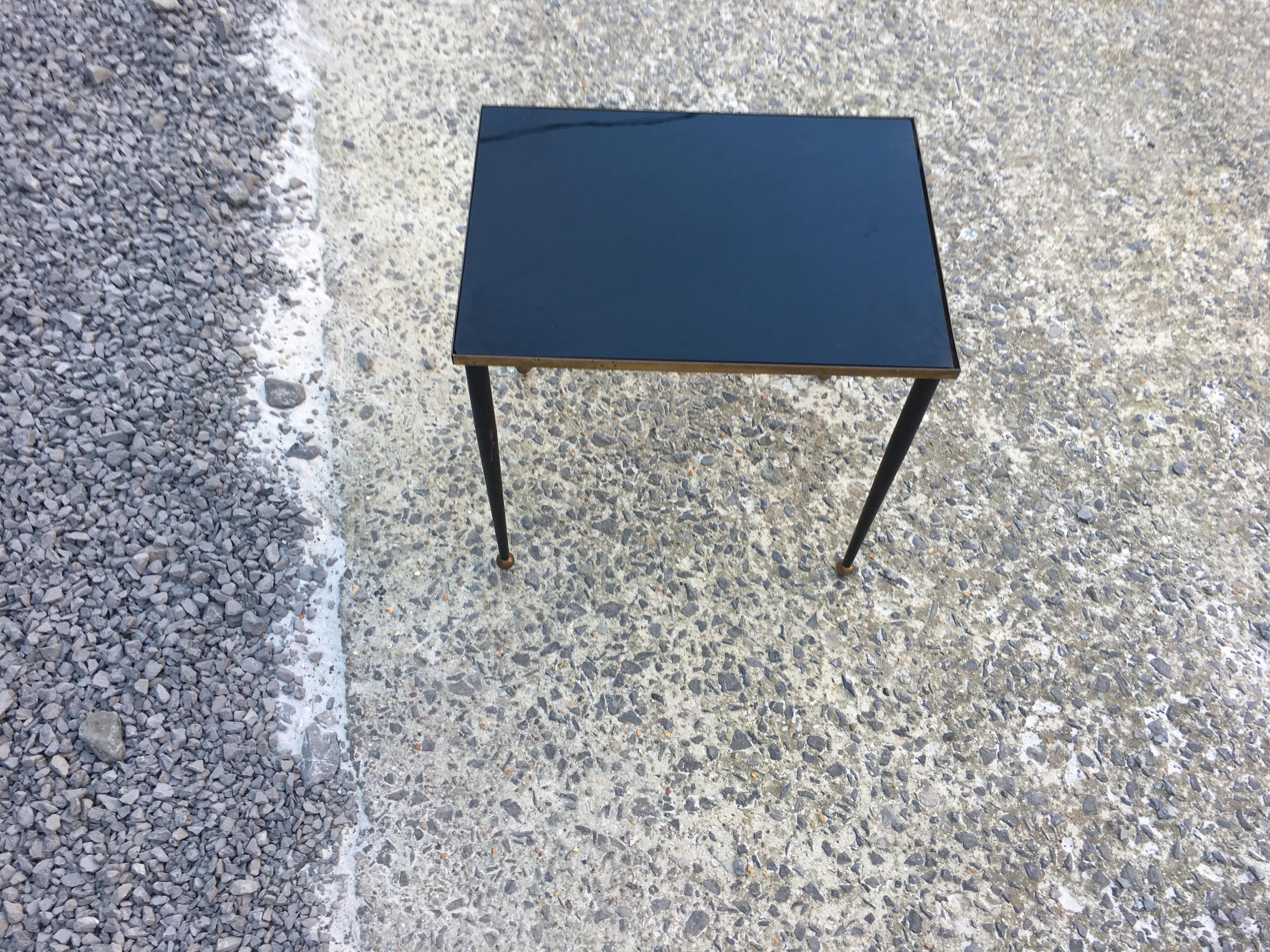 In the style of René Prou, elegant side table in lacquered and gilded metal, tray made of black glass, circa 1940.