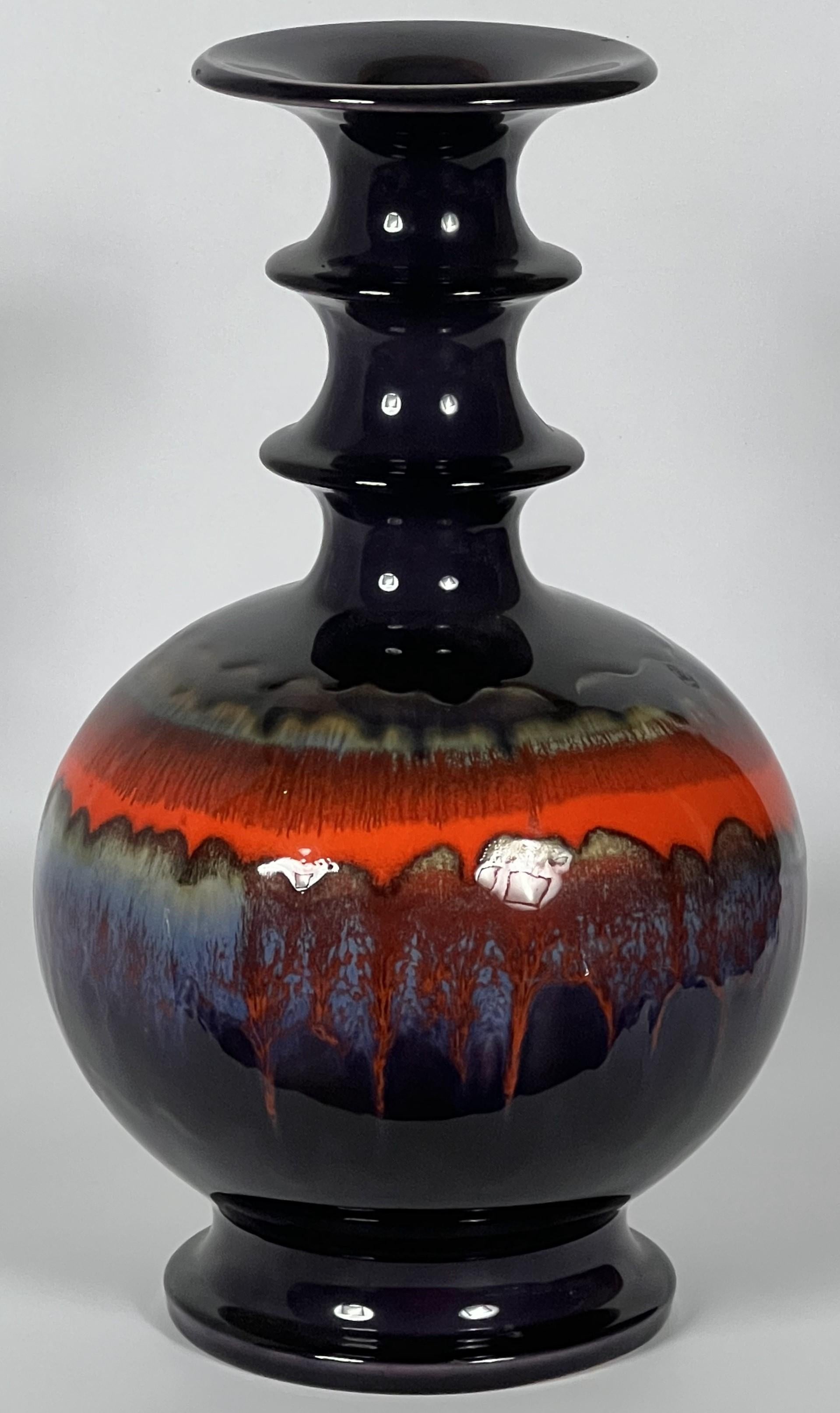 Renee Neue's designs at Hutschenreuther are some of the most vibrant space age ceramics produced. This vase is absolutely atomic as the repeating bands along the neck appear to erupt from the surface of a sun as if a nuclear explosion has disturbed