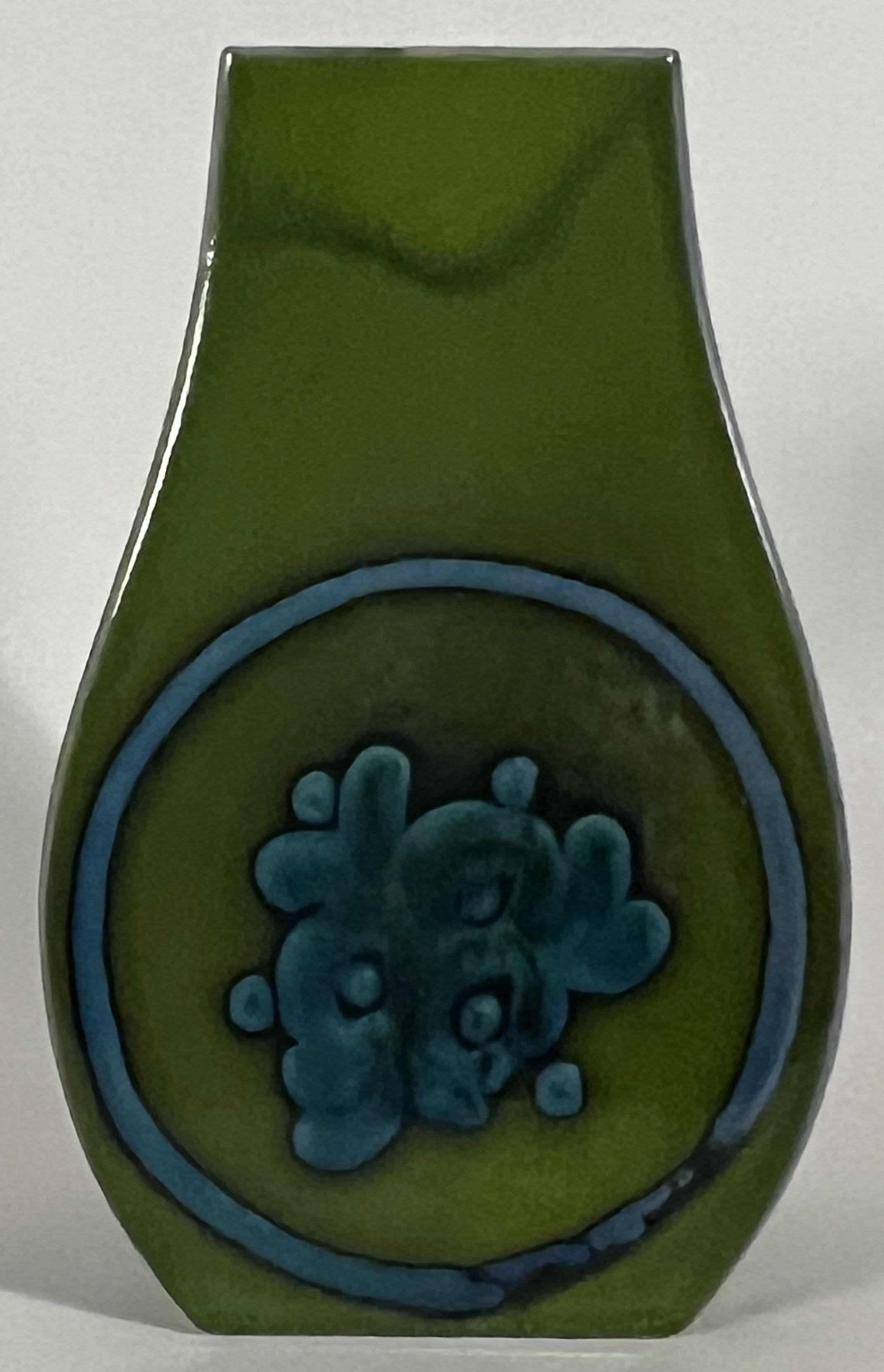 Renee Neue's designs at Hutschenreuther are some of the most vibrant 70's era ceramics produced. This elegant form is inspired by antique Chinese Bronzes and the color and decorations both complement and contemporize the form. The vibrant green