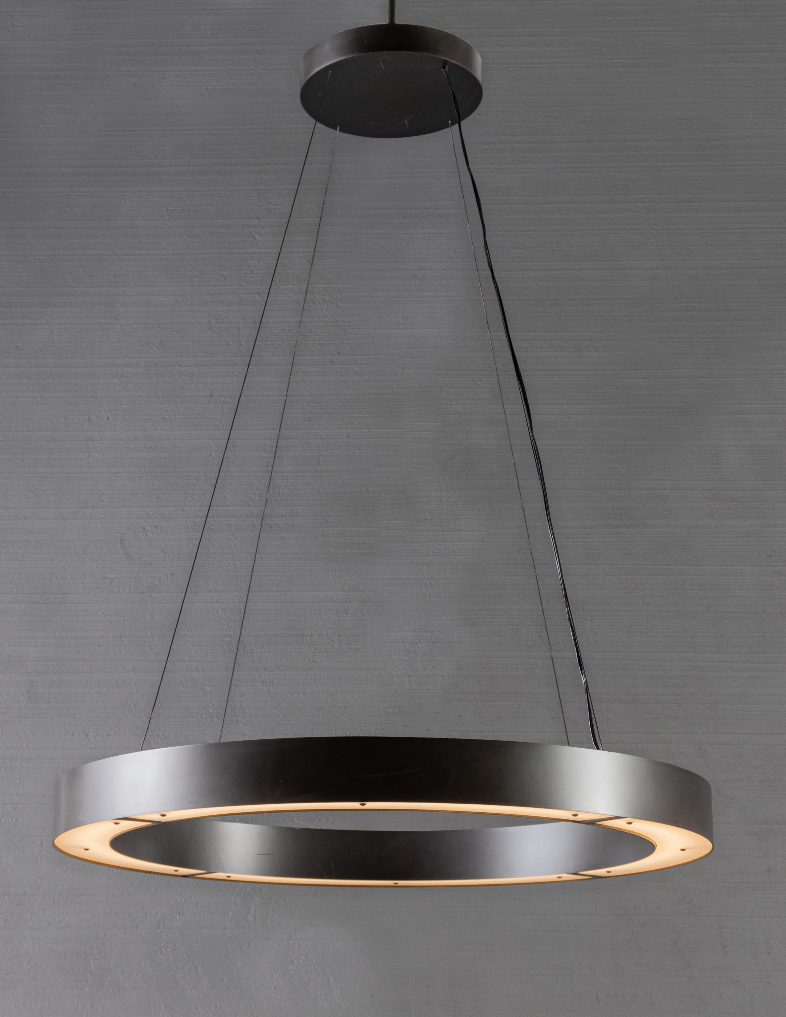 Modernist suspension ring light. Bulb LED continuous loop.

Bronze tone steel body with steel cable suspension. Height is adjustable.

Handcrafted in Italy. Sold exclusively at Brendan Bass.

Minimum hanging height: N/A
Maximum hanging height: