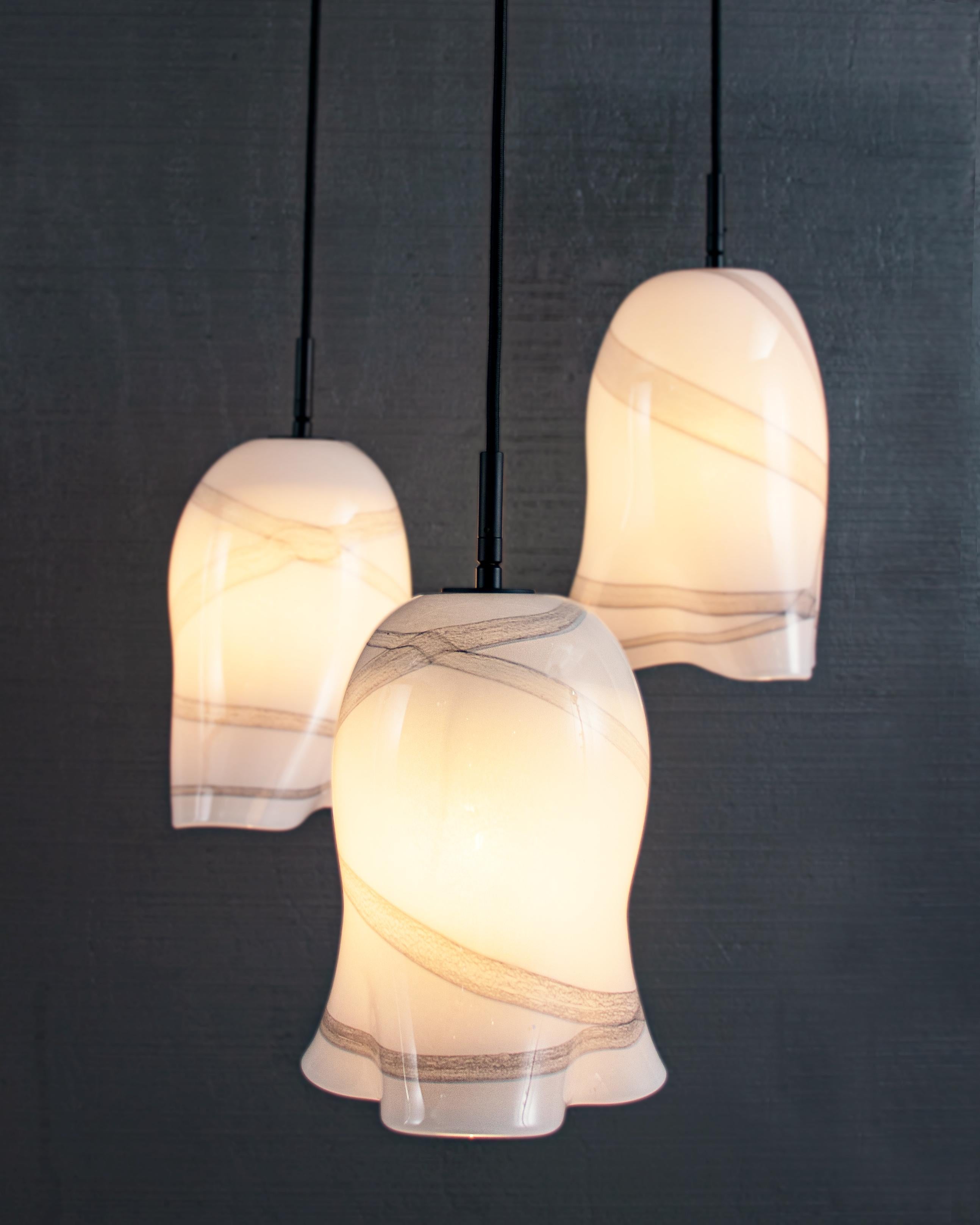 Decorated glass handcrafted lighting feature with artisanal cast.

Bulb 1 medium base 60 Watt incandescent. 5lbs.

The Kama pendant is a mouth blown glass form which celebrates the ageless craft of artisanal glass. Formed in a wooden mould, removed