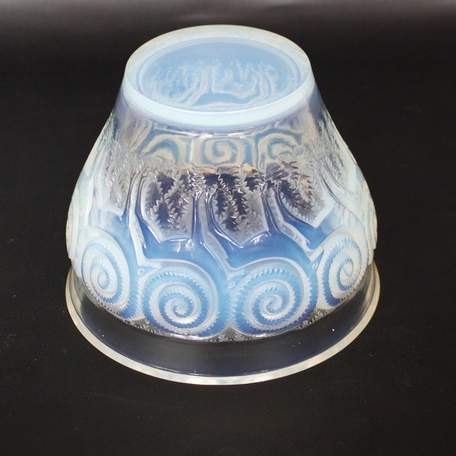 Rennes, an Art Deco, opalescent and clear glass vase, relief decorated with stylized reindeer and moss.

Etched R Lalique France to underside.

Marcilhac, R Lalique Catalogue Raisonné de L’Œuvre de Verre p.459, Model number 10-875. Model first