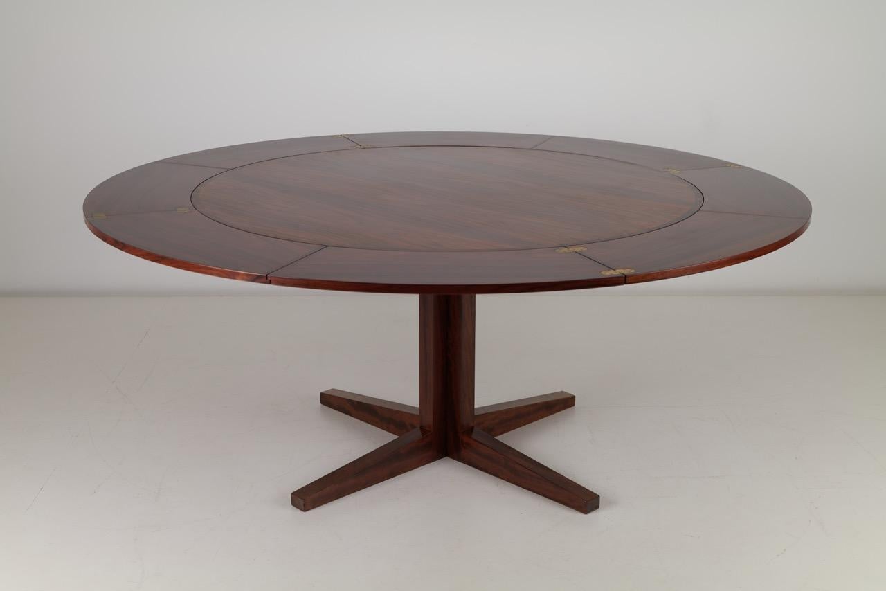The lotus table is a masterclass in Scandinavian craftsmanship and innovative design. This striking table combines functional versatility with the luxurious beauty of rosewood, offering both aesthetic elegance and practical use.

Featuring the