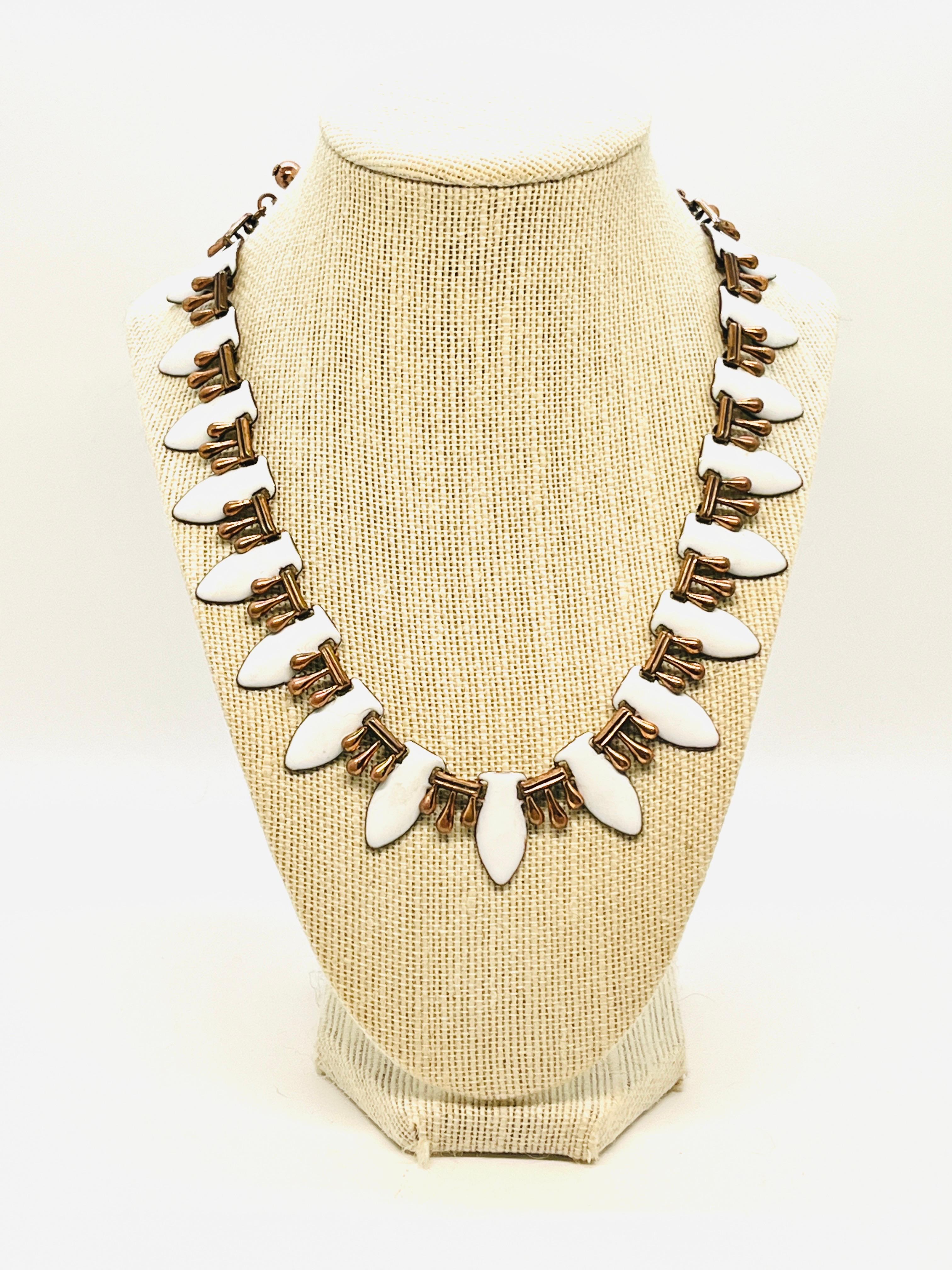 This is a marked Renoir Copper and White Enamel necklace, from the 1950s. Adjustable 14