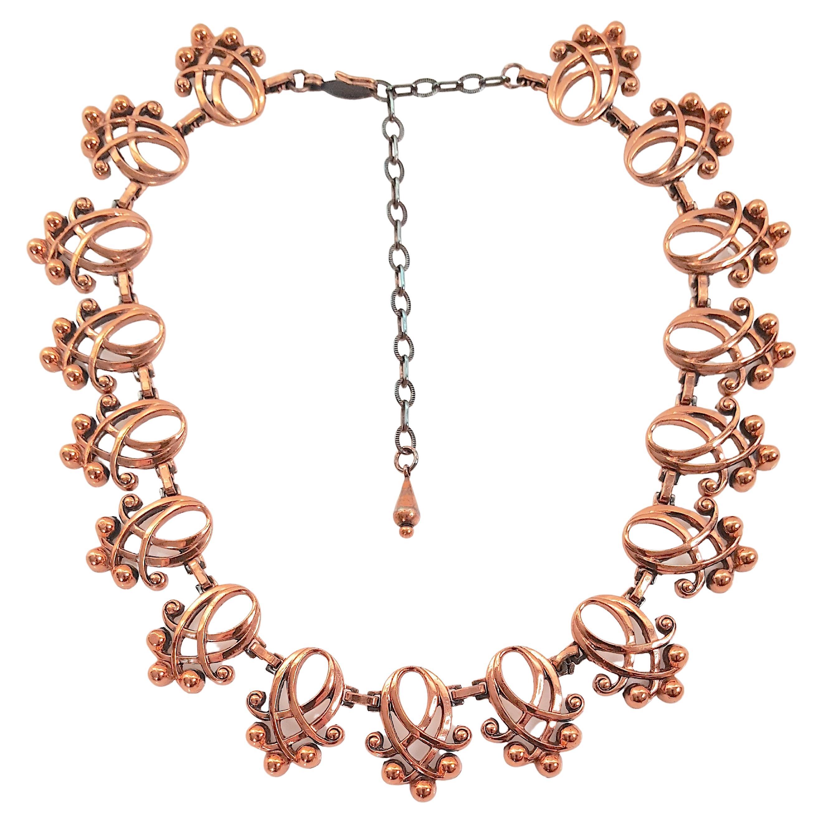 With organically-shaped copper openwork links recalling the rhythmic motifs of American architect Louis Sullivan from the Art-Nouveau period, this Renoir mid-century curvilinear 17-link necklace is signed on the hook of its clasp. An extension chain