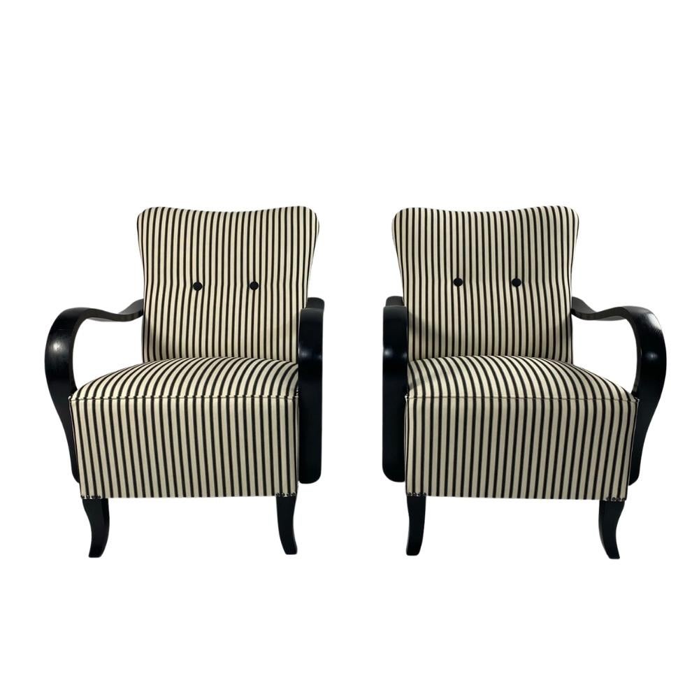 Keeping in mind the sustainable future, the knowledge of old masters and the durability of the artefacts, we conjured up this striped Jindrich Halabala armchair pair. Completely rethought solid wood with matte black legs and armrests, elegant black