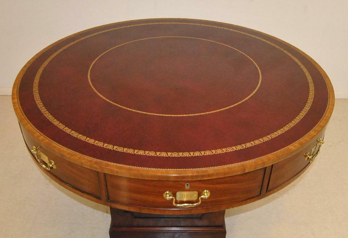 Rent circular table in mahogany by Henkel Harris Moore circa 1991. Top has leather center with a decorative gold border. Top swivels and there are eight drawers and center compartment in the pedestal. Finished on all sides. Very nice condition with