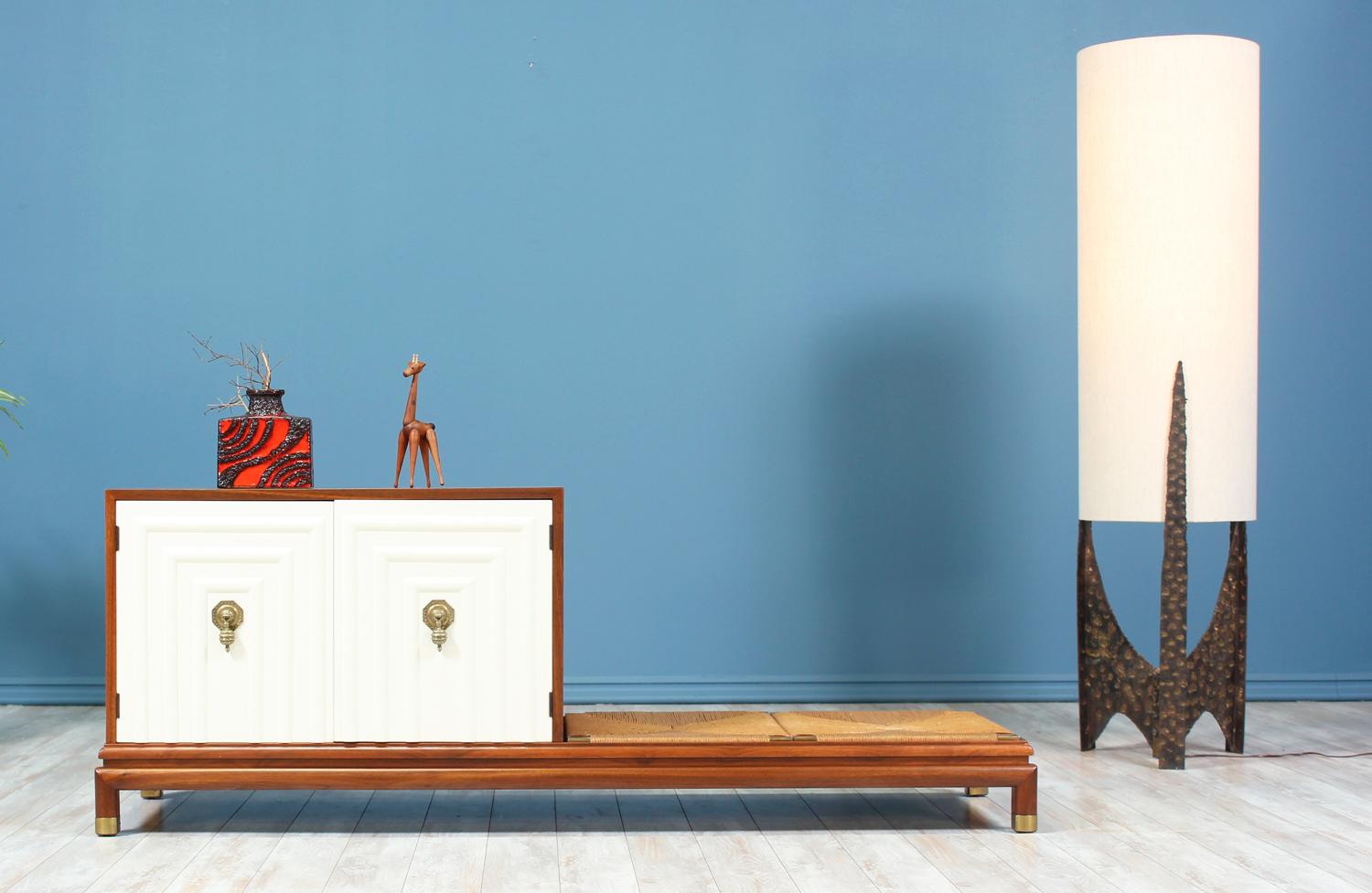 Gorgeous credenza designed by Renzo Rutili for Johnson Furniture in the United States circa 1950’s. Comprised of a walnut case, this newly refinished piece features white lacquered doors with Rutili’s signature maze design and solid brass intricate