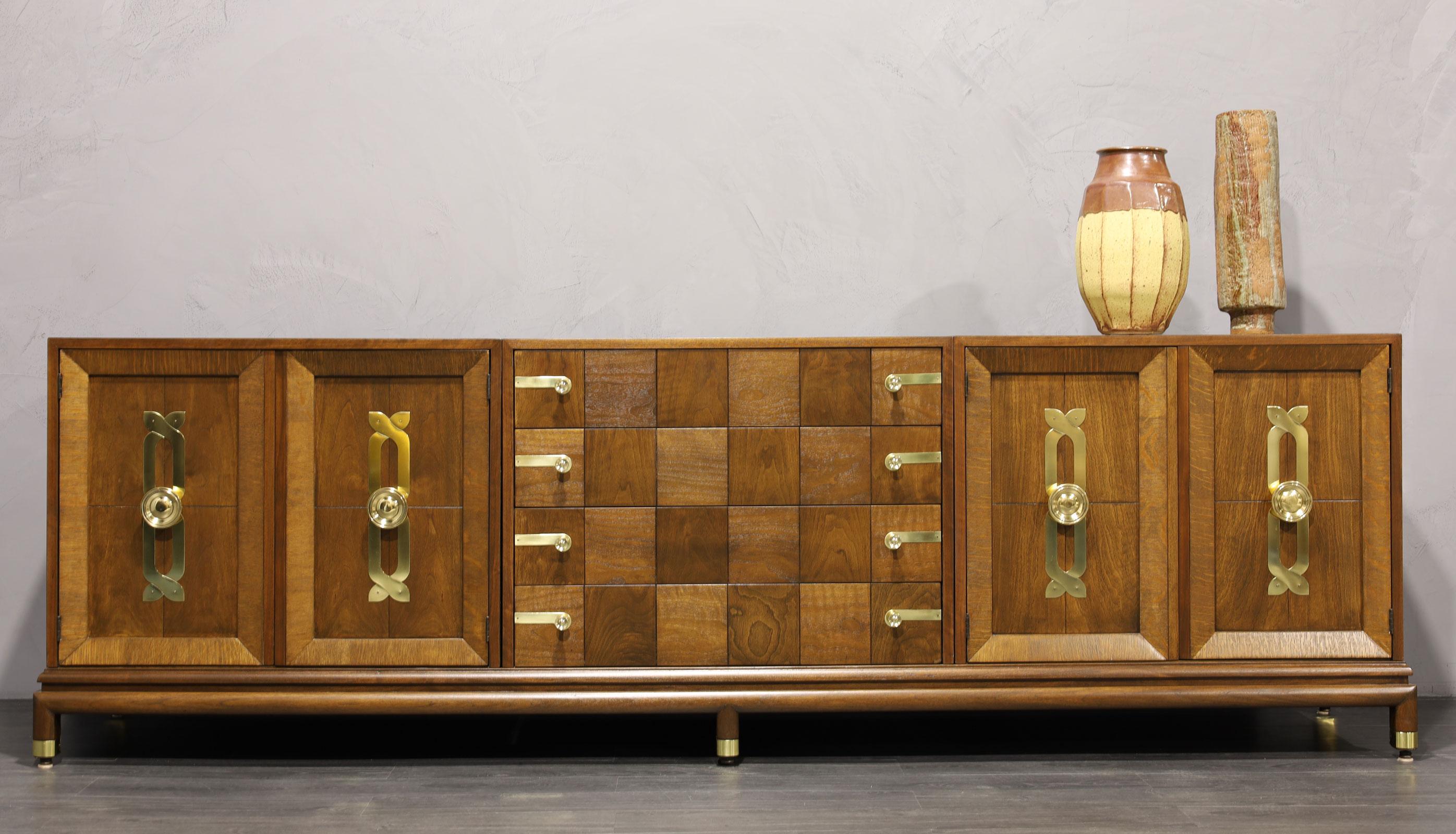 We have fully restored this beautiful sideboard by Renzo Rutili for John Stuart/Johnson Furniture Company. The sideboard features three separate cabinets that rest in a single base. Beautiful brass hardware throughout. The brass has been polished