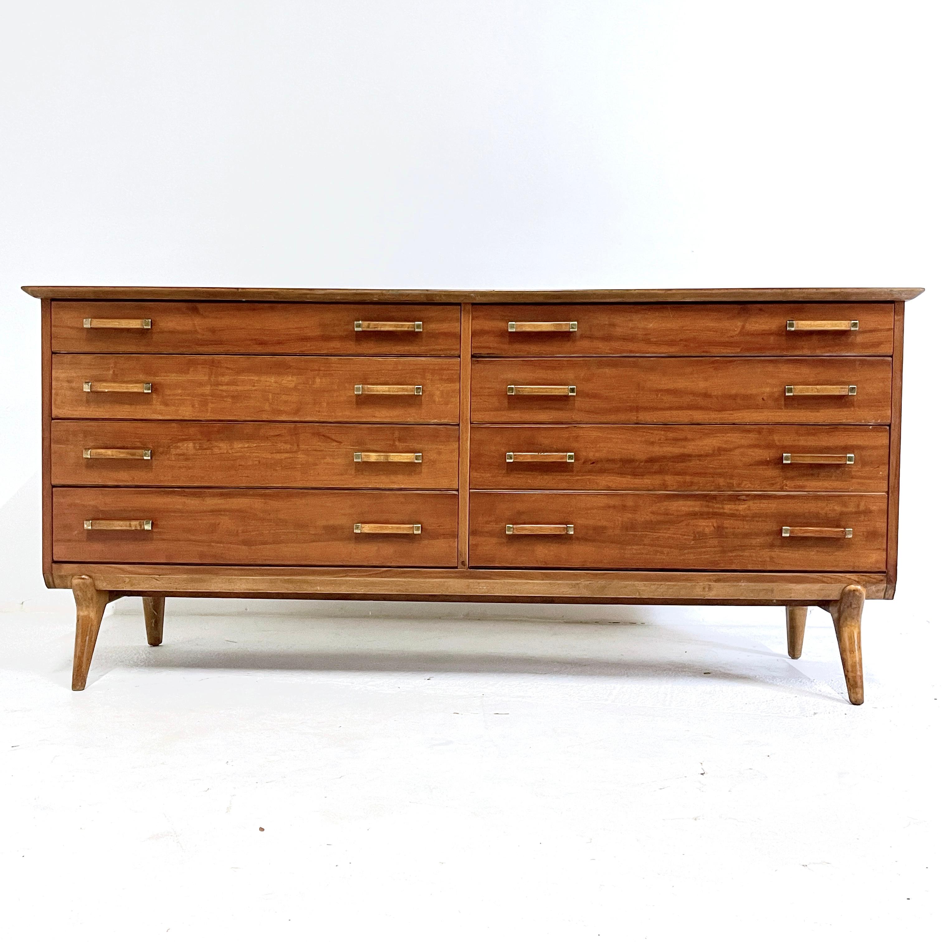 Exceptional sculptural solid cherry dresser designed by Renzo Rutili. This piece retains both the Johnson Furniture Company stamp as well as the metal John Stuart Inc. metal tag. Expertly refinished to perfection. Stunning carved lines on both the