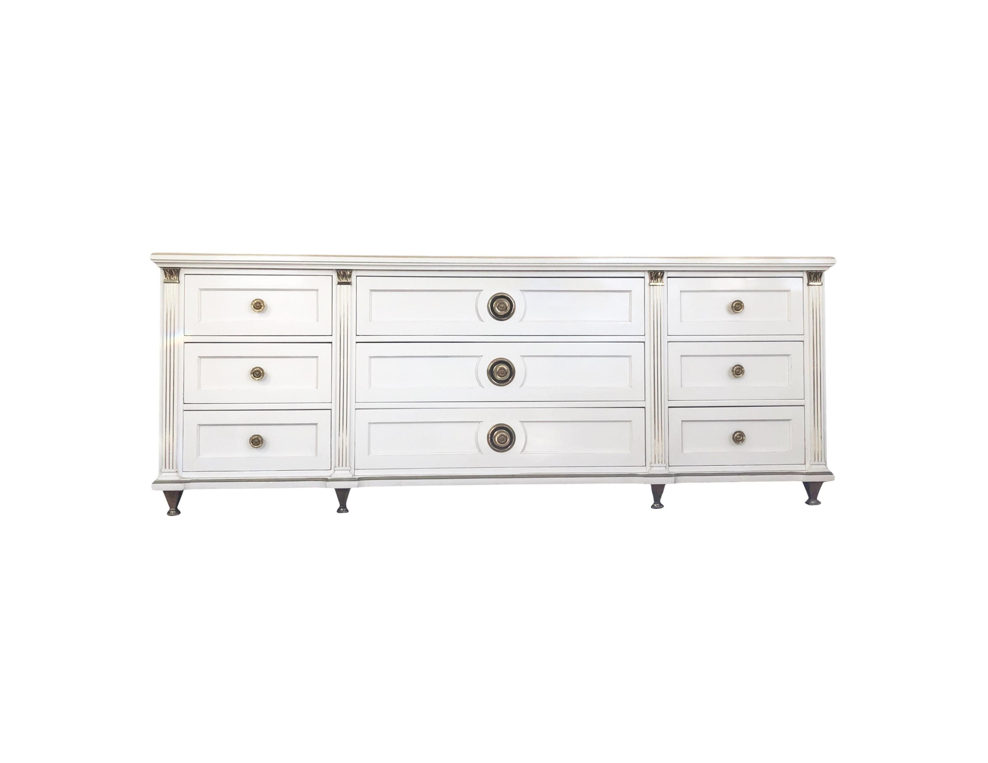A stunningly sophisticated design from the 1960's, this piece feels like Renzo Rutili but is from a rare series by American of Martinsville. A modern interpretation on refined neoclassic design, this nine-drawer dresser/sideboard has a cool vibe, is