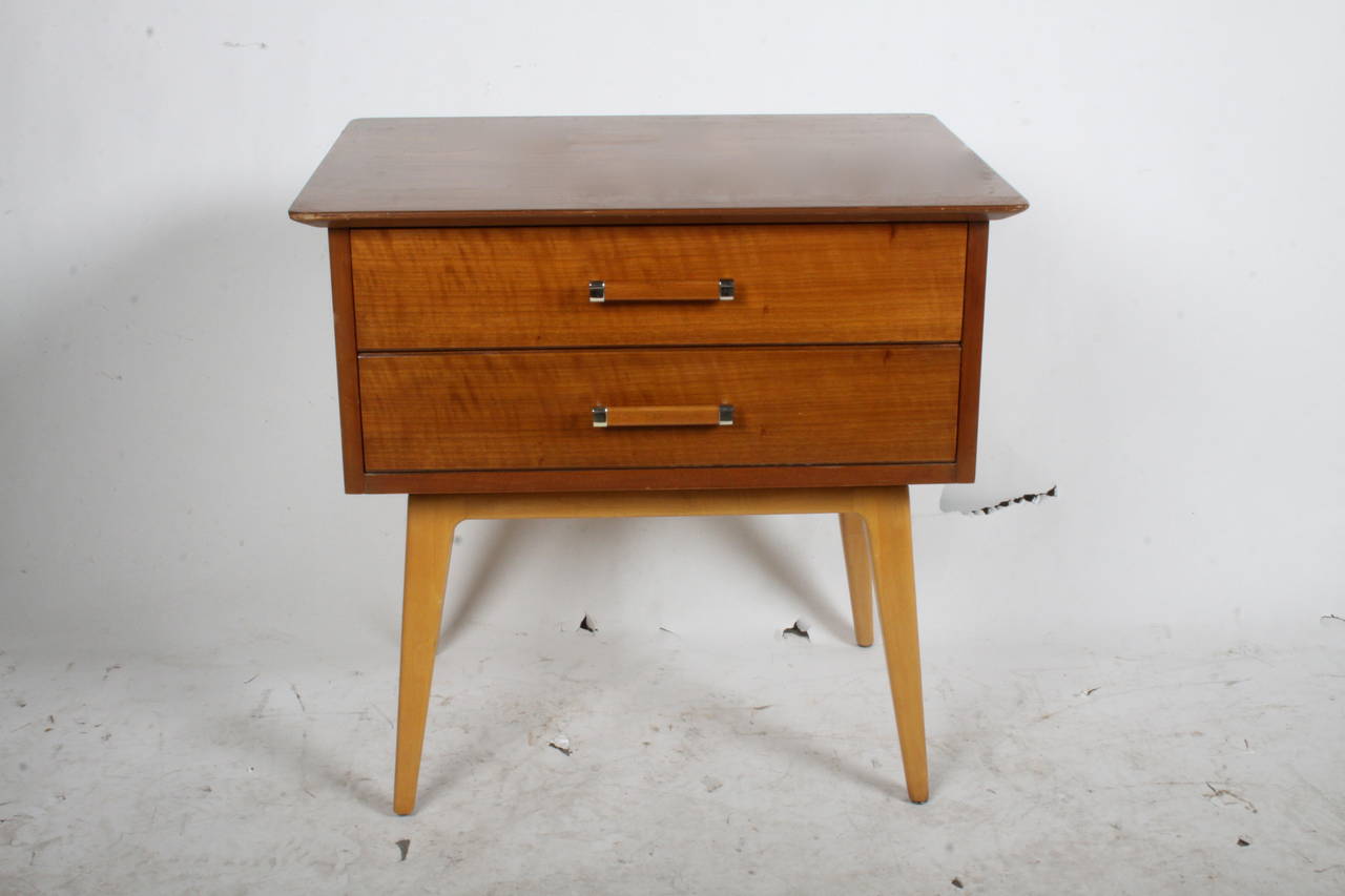 Two drawer Mid-Century Modern cherry nightstand, circa 1950s, designed by Renzo Rutili for Johnson Furniture Company. To be refinished prior to shipping, please allow several weeks.