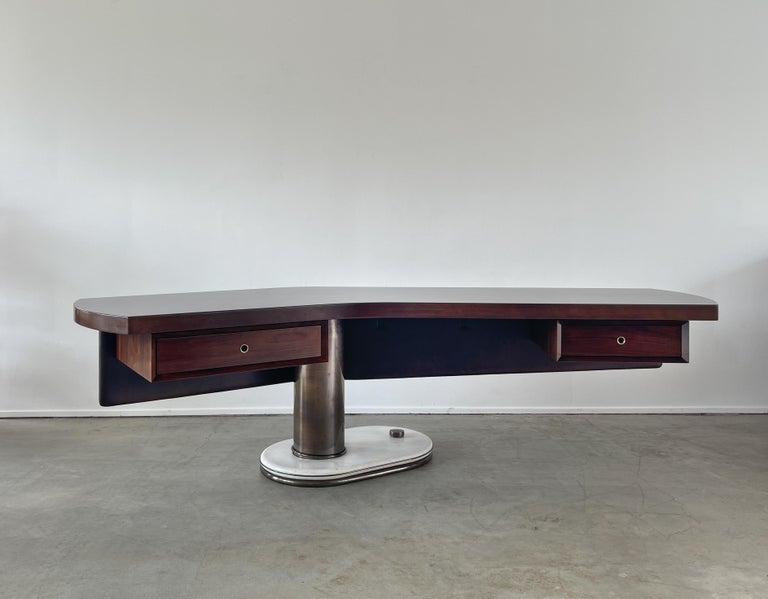 An incredible Italian desk by artist Renzo Schirolli - 
Boomerang shaped walnut top with floating leatherette covered modesty panel and pedestal drawers 
Cylindrical bronze column sits on solid marble base supporting cantilevered asymmetrical desk