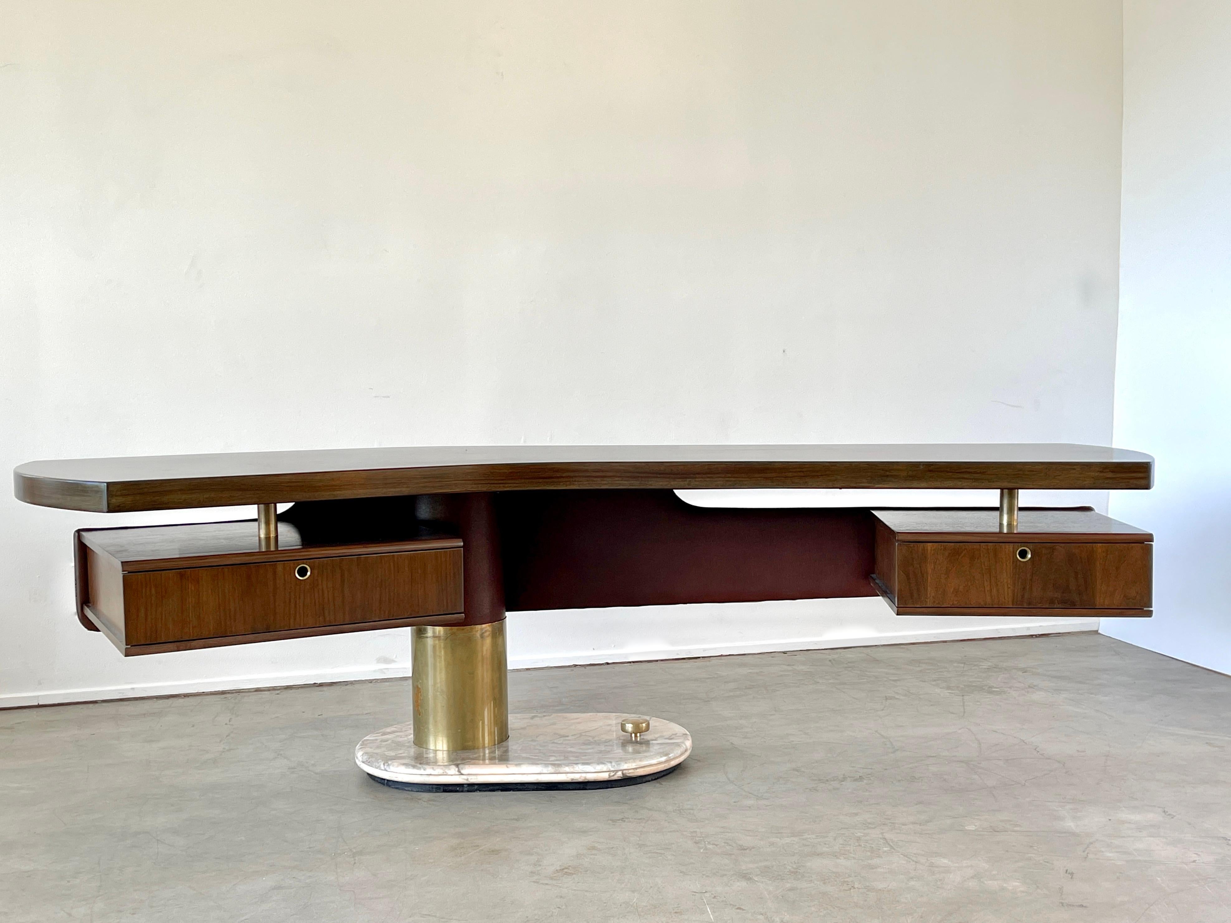 An incredible Italian desk by artist Renzo Schirolli -
Boomerang shaped walnut top with floating leatherette covered modesty panel with floating pedestal drawers - which have original red lacquer interiors. 
Cylindrical bronze column sits on solid