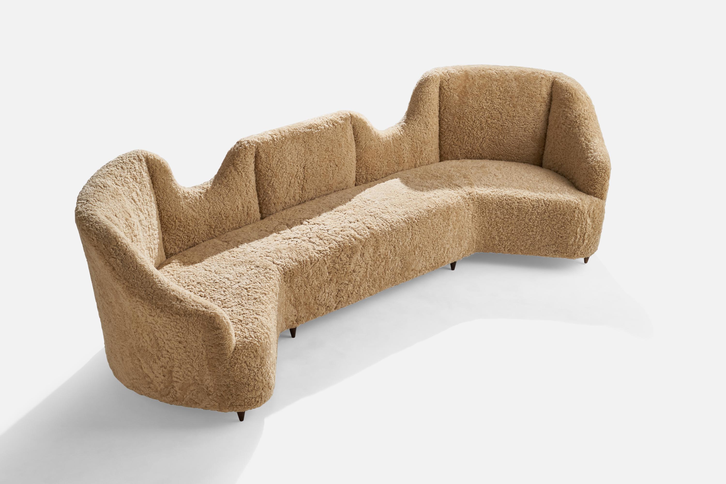 A large shearling and stained wood sofa attributed to Renzo Zavanella, Italy, 1940s.

Seat height 18”

