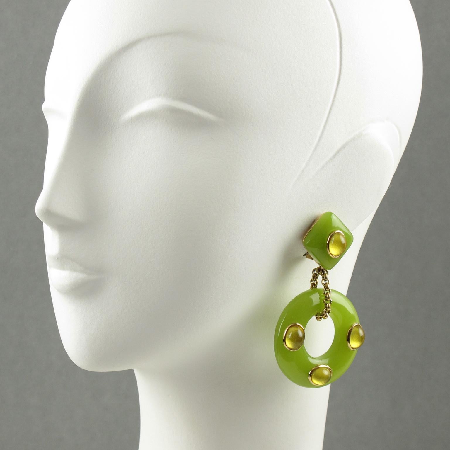 These lovely resin dangling clip-on earrings by Replica Italy are certain to enhance the beauty and elegance of any collection or outfit. They are made of gold plated metal set on dangling resin donut in apple green color topped with vaseline resin