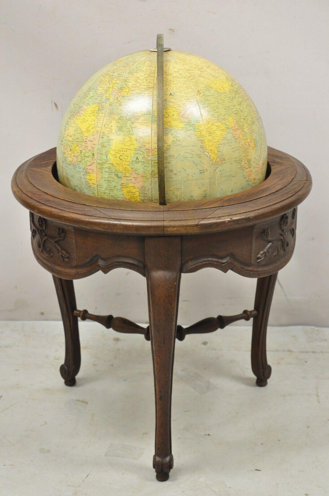 Vintage Replogle Globes French Country Provincial style Revolving floor globe oak stand. Item features fiberglass revolving globe, solid wood frame, beautiful wood grain, distressed finish, nicely carved details, cabriole legs. Circa mid 20th