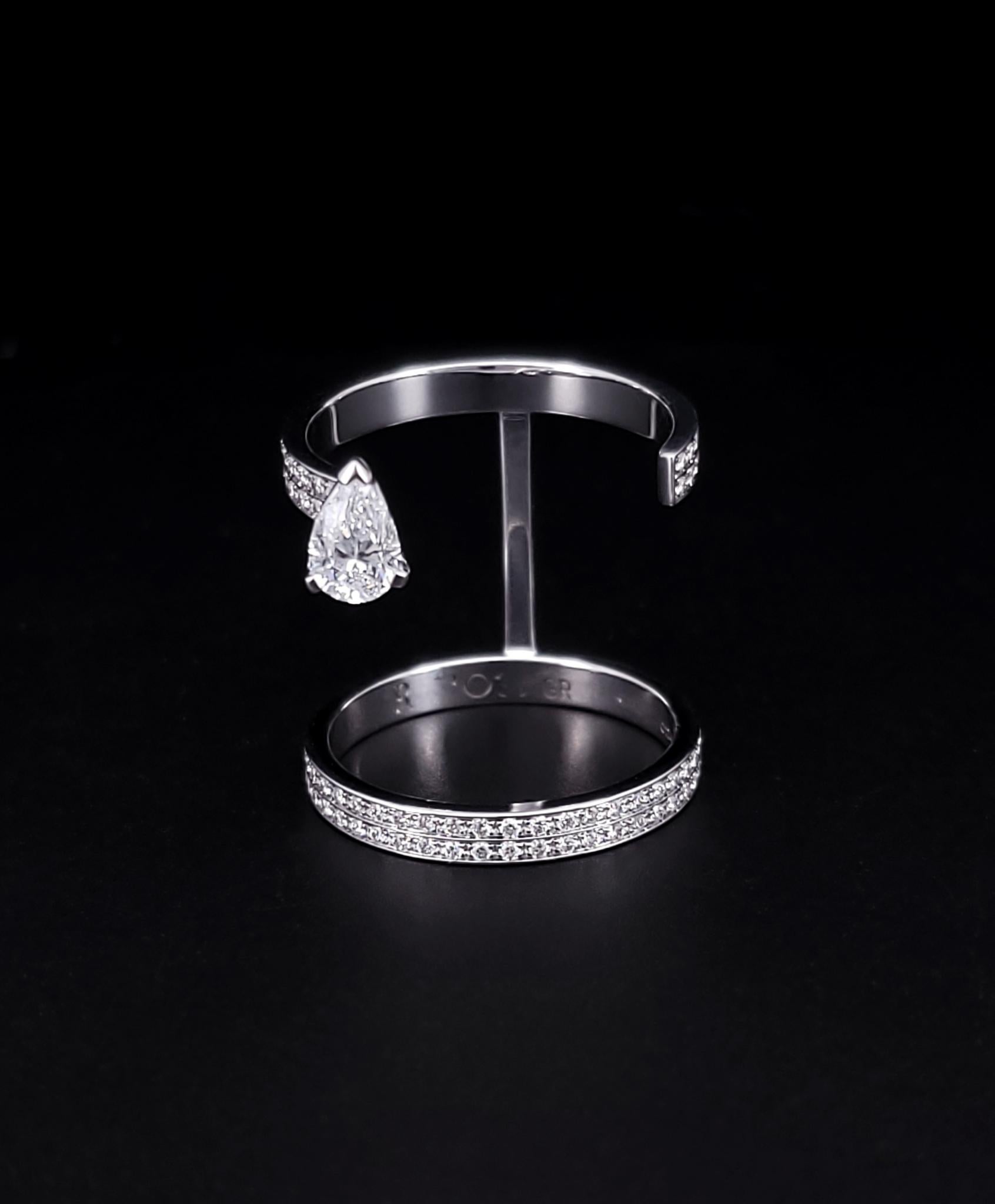A breathtaking reinterpretation of the solitaire, with a paved ring and a floating diamond.

Brand: Repossi
Model: Serti sur Vide
Material: 18k white gold
Condition: Like-new, mint
Size: 5.75
Weight: 4.3 grams
Thickness: 2.5mm (each ring)
Height: