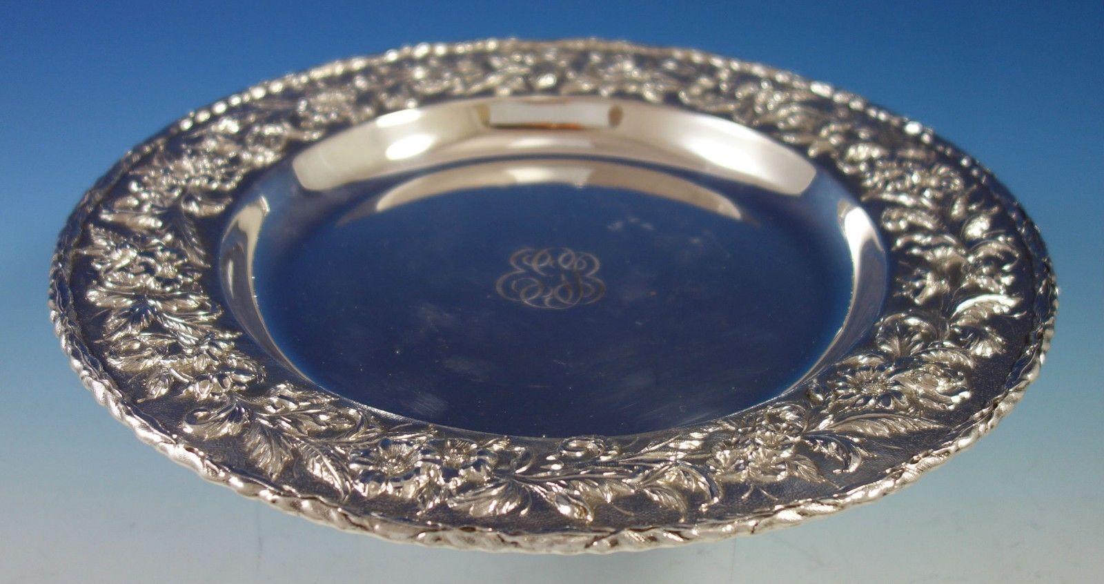 Repousse by Kirk sterling silver round shallow serving platter / tray. The piece is hand decorated, and it has a wide band of flowers and leaves in excellent repousse design. The piece is marked #2503, it measures 13 in diameter x 1 , and weighs